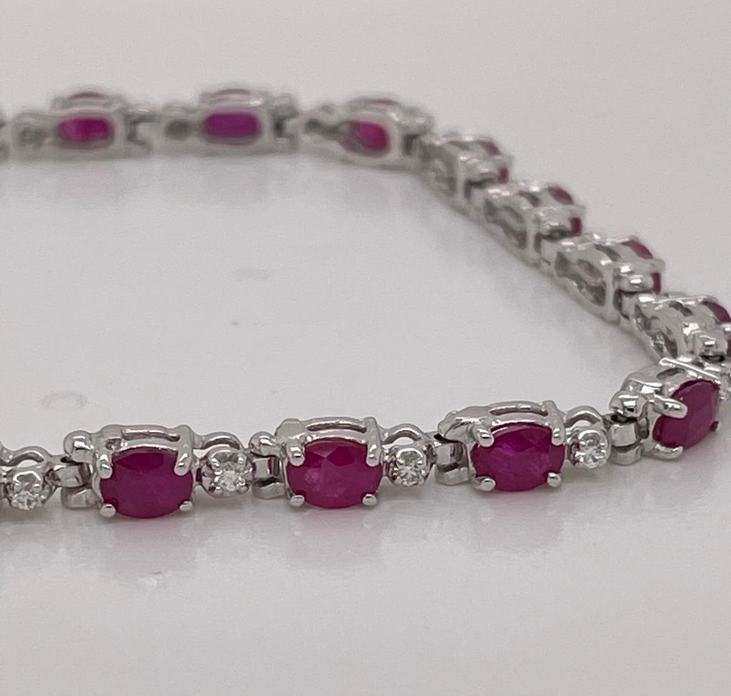 22 pieces of oval rubies weighing 5.12 cts
Measuring (4.0x3.0) mm
22 pieces of round diamonds weighing .21 cts
Set in 14K white gold bracelet
Weighing 6.70 grams