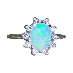 Vintage 14 Karat White Gold Oval Shaped Australian Opal Ring with Diamond Halo
