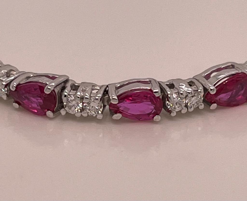 20 pieces of pear shape rubies weighing 4.12 cts
Measuring (5.0x3.0) mm
38 pieces of diamonds weighing .79 cts
Set in 14K white gold bracelet
Weighing 8.50 grams