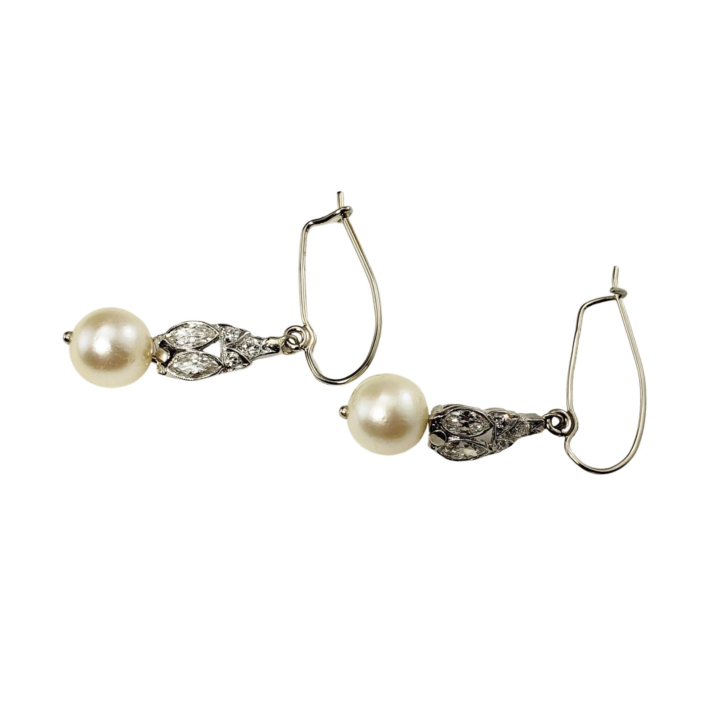 14 Karat White Gold Pearl and Diamond Dangle Earrings-

These lovely dangle earrings each feature one round 8 mm pearl, four marquis diamonds and six round brilliant cut diamonds set in classic 14K white gold.

Approximate total diamond weight: .45