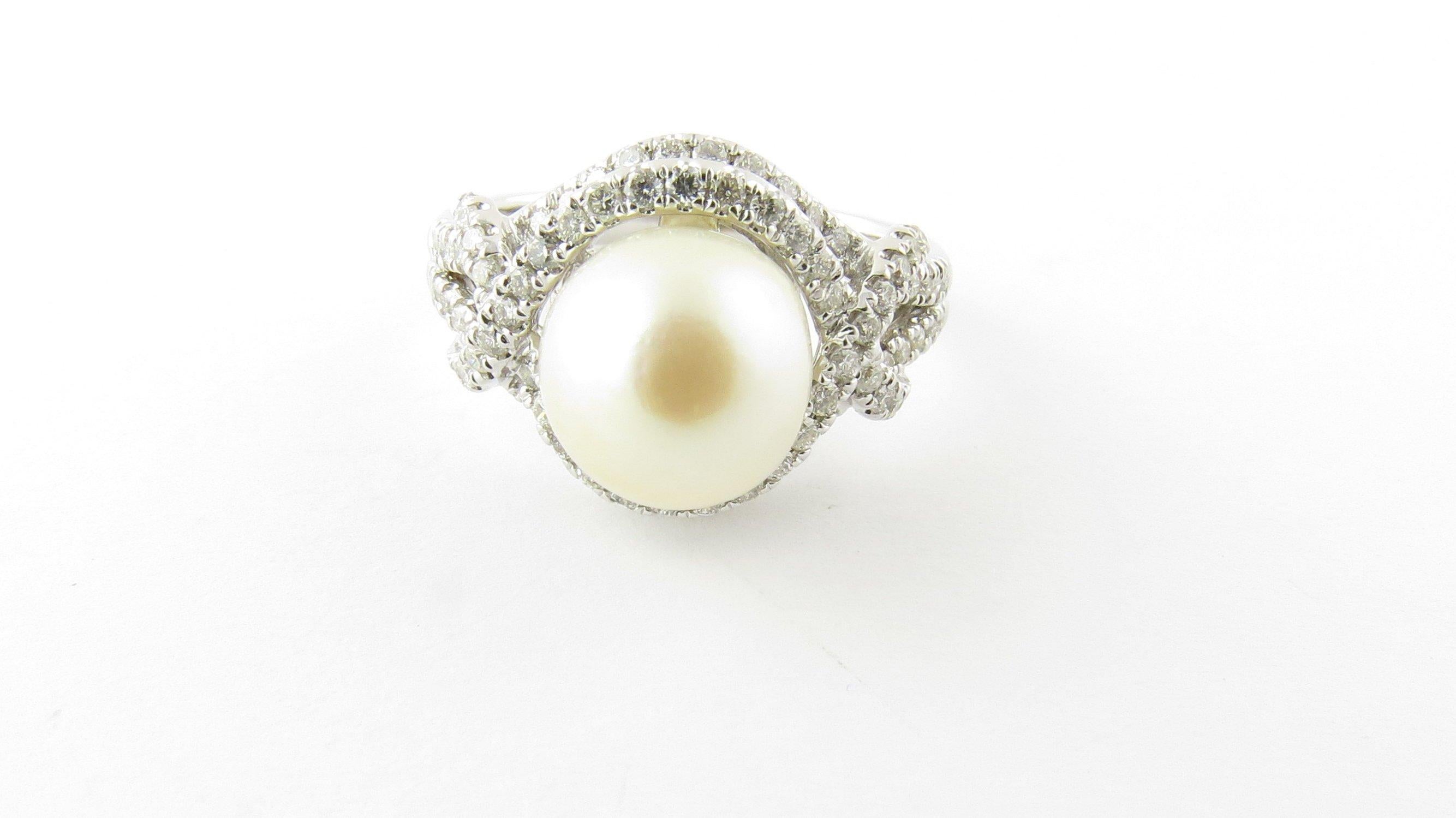 Vintage 14 Karat White Gold Pearl and Diamond Ring Size 6.75- This stunning ring features one cultured pearl (8.5 mm) surrounded by 78 round brilliant cut diamonds set in classic 14K white gold. Shank measures 2 mm. Approximate total diamond weight:
