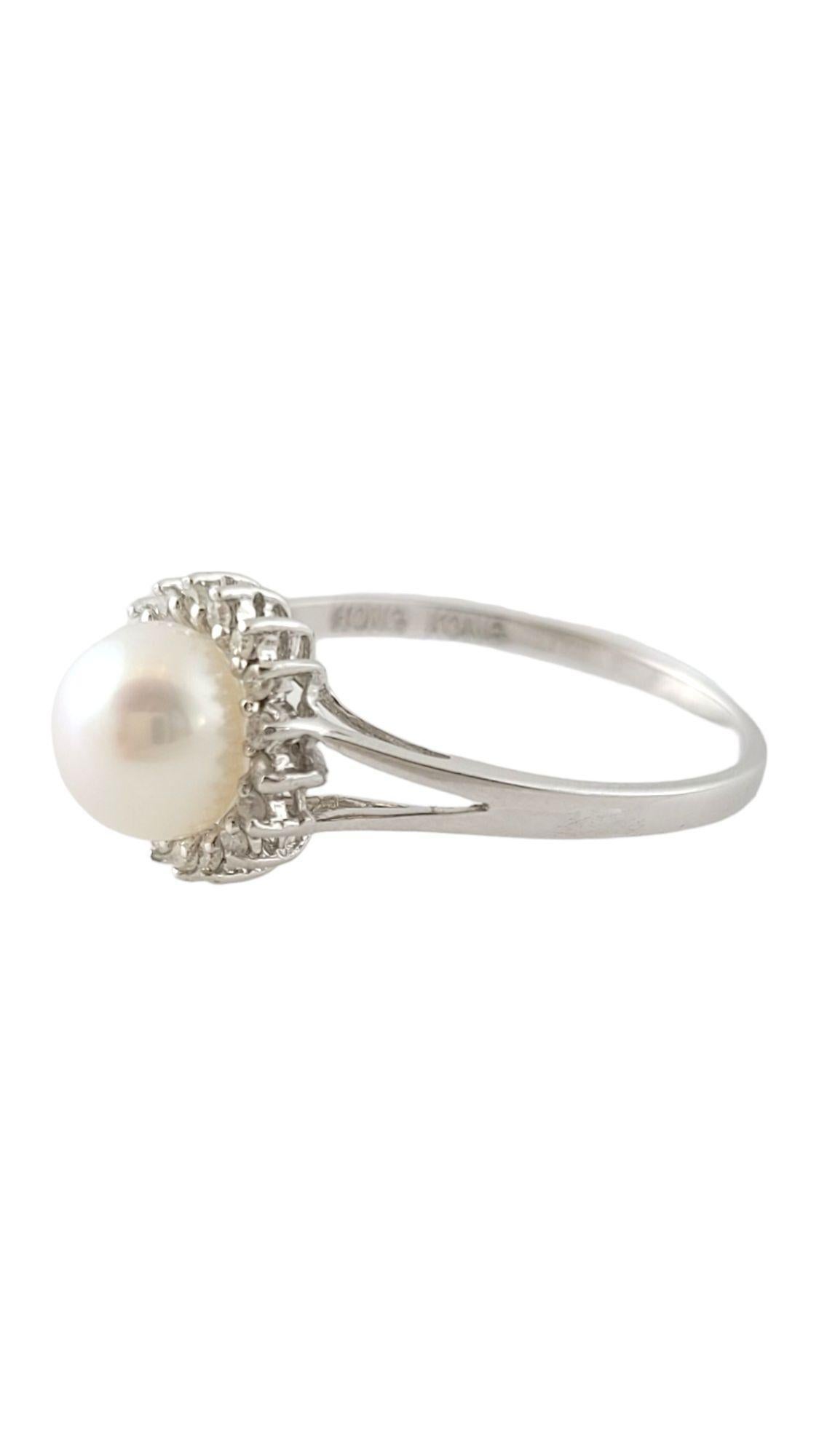 Vintage 14 Karat White Gold Pearl and Diamond Ring Size 9.25-

This elegant ring features one round white pearl (7 mm) and 18 round single cut diamonds set in classic 14K white gold. Shank: 1.5 mm. 
Width: 10 mm.

Approximate total diamond