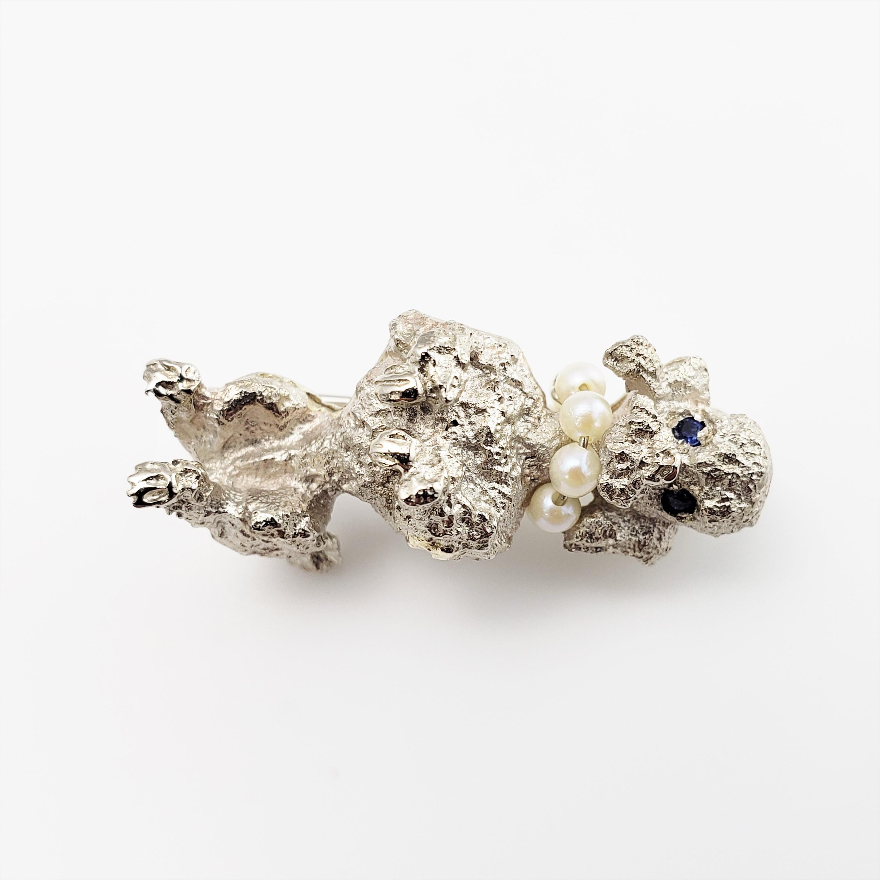14 Karat White Gold, Pearl and Sapphire Poodle Brooch/Pin-

This lovely poodle brooch features two sapphire eyes and a pearl collar (eight 2 mm pearls) crafted in beautifully detailed 14K white gold.

Size:  1.2 inches x 0.5 inches

Weight:  5.0