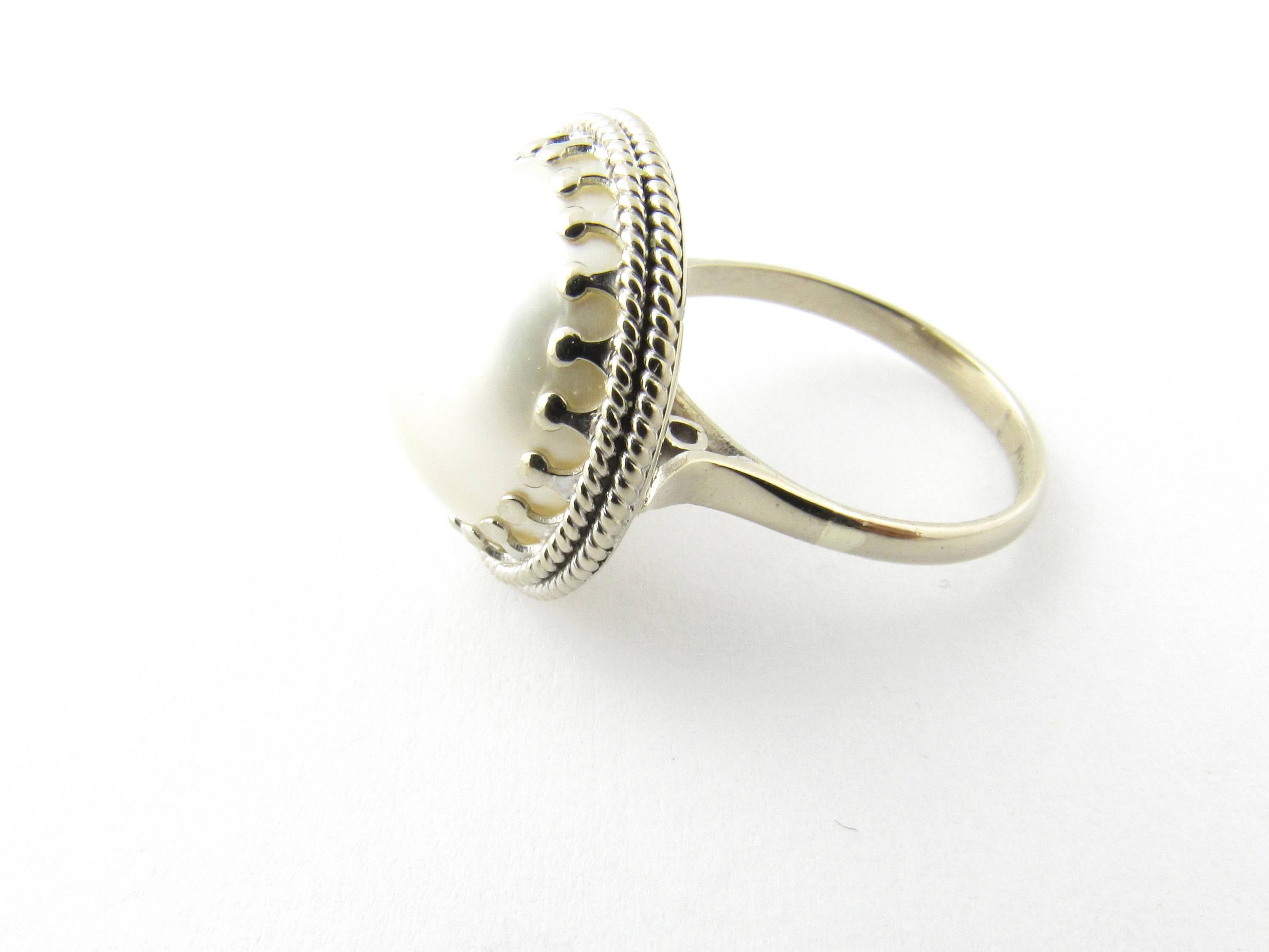 Vintage 14 Karat White Gold Pearl Ring Size 5.75- 
This lovely ring features a stunning pearl (15 mm) framed in beautifully detailed 14K white gold. Top of ring measures 18 mm. Shank measures 2 mm. 
Ring Size: 5.75 
Weight:  3.7 dwt. /  5.9 gr.