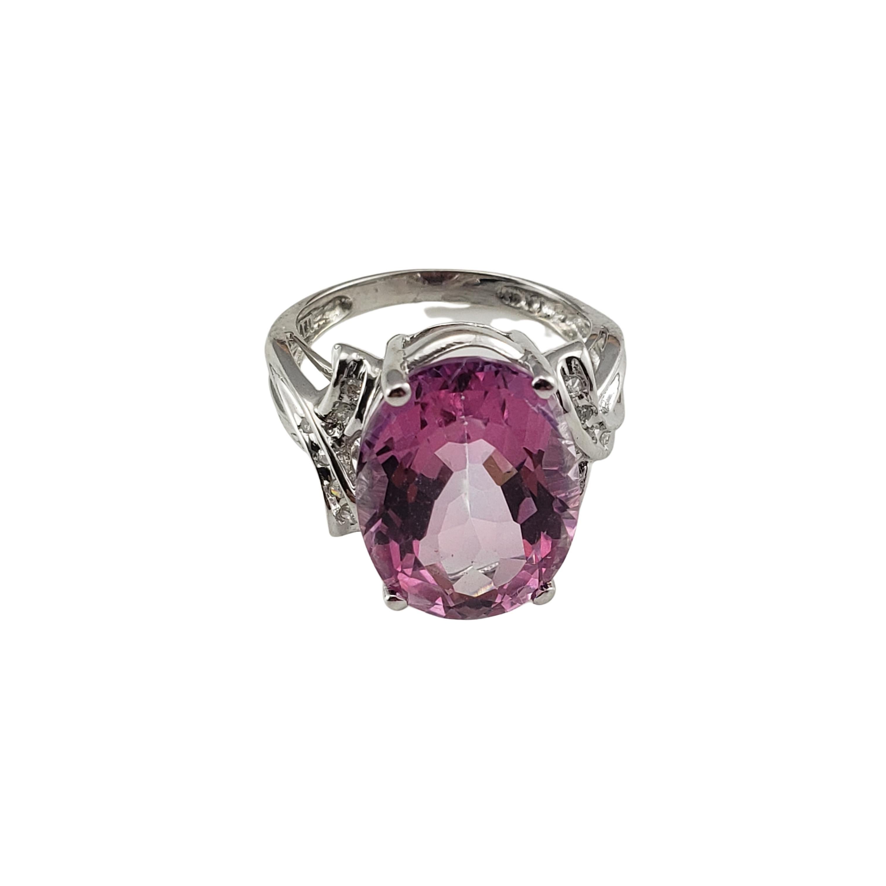 14 Karat White Gold Pink Glass and Diamond Ring Size 6 GAI Certified-

This elegant ring features one oval pink glass stone (16 mm x 11 mm) and 12 round single cut diamonds set in classic 14K white gold. Shank:  2 mm.

Total diamond weight:  .12