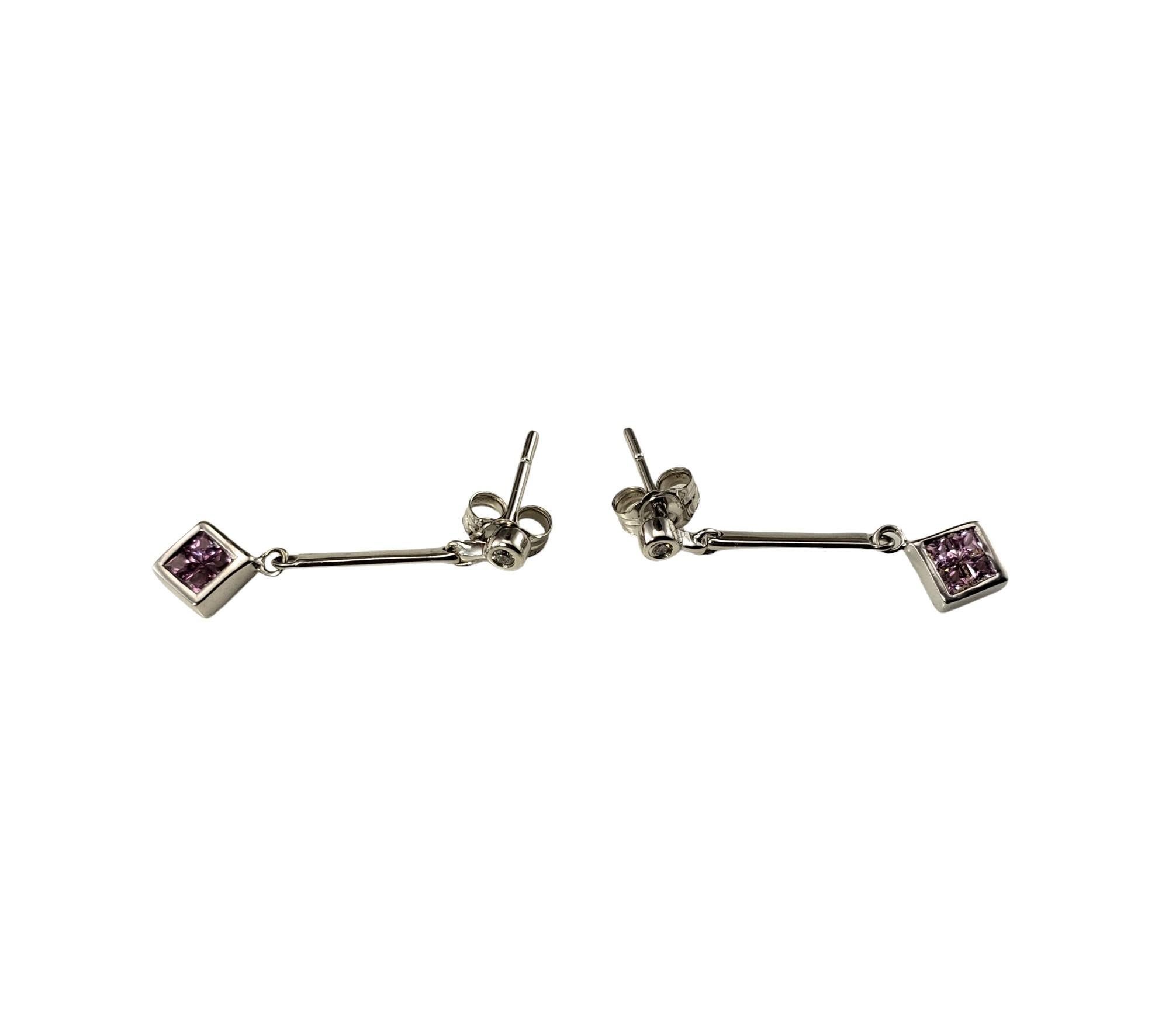 Vintage 14K White Gold Pink Sapphire and Diamond Dangle Earrings-

These elegant dangle earrings each feature four square pink sapphires and one round brilliant cut diamond set in classic 14K white gold.

Approximate total diamond weight: .04