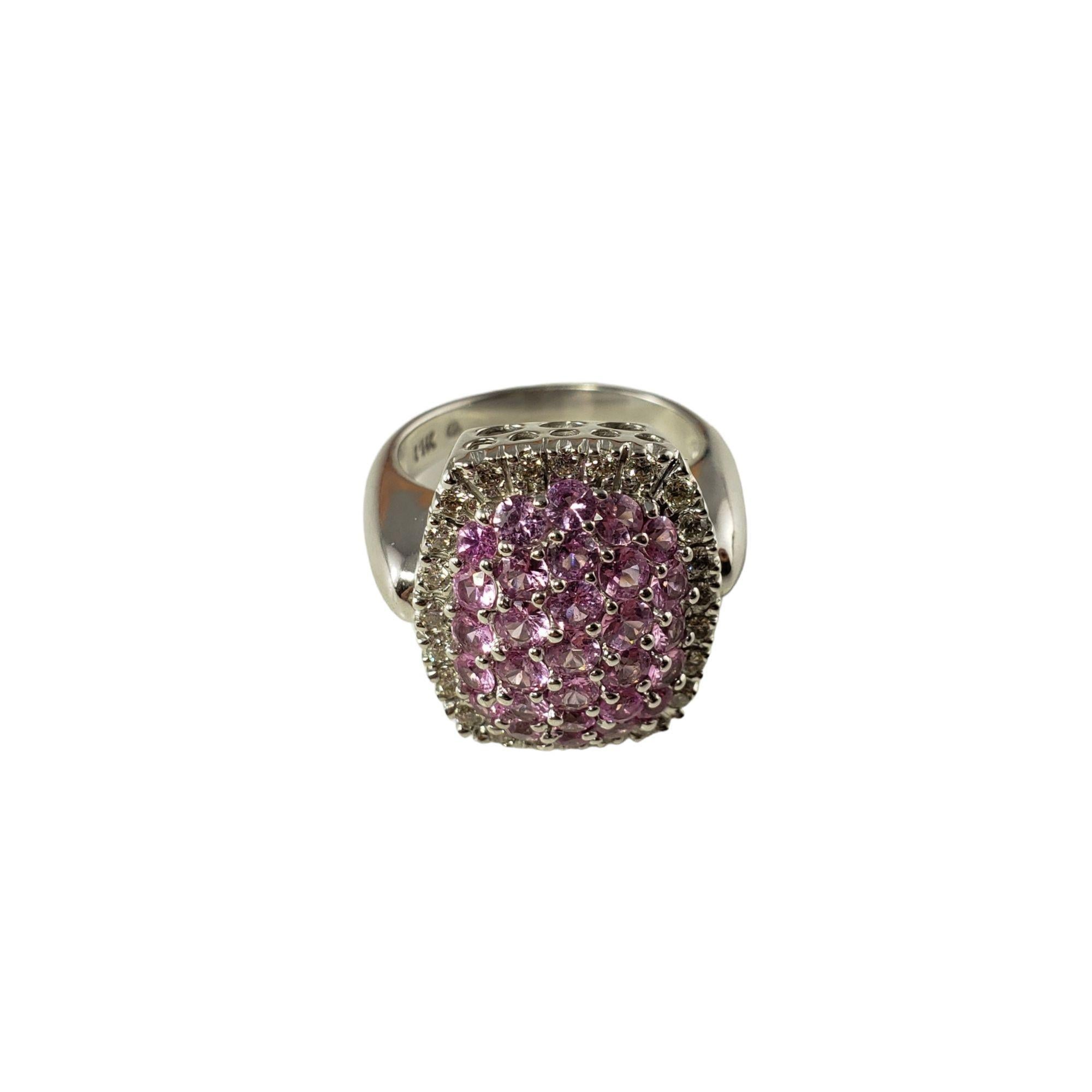 This sparkling ring features 29 pink sapphires and 24 round brilliant cut diamonds set in beautifully detailed 14K white gold.  

Top of ring measures 18 mm x 16 mm.  Shank:  3 mm.

Total sapphire weight:  3.49 ct.

Total diamond weight: .44