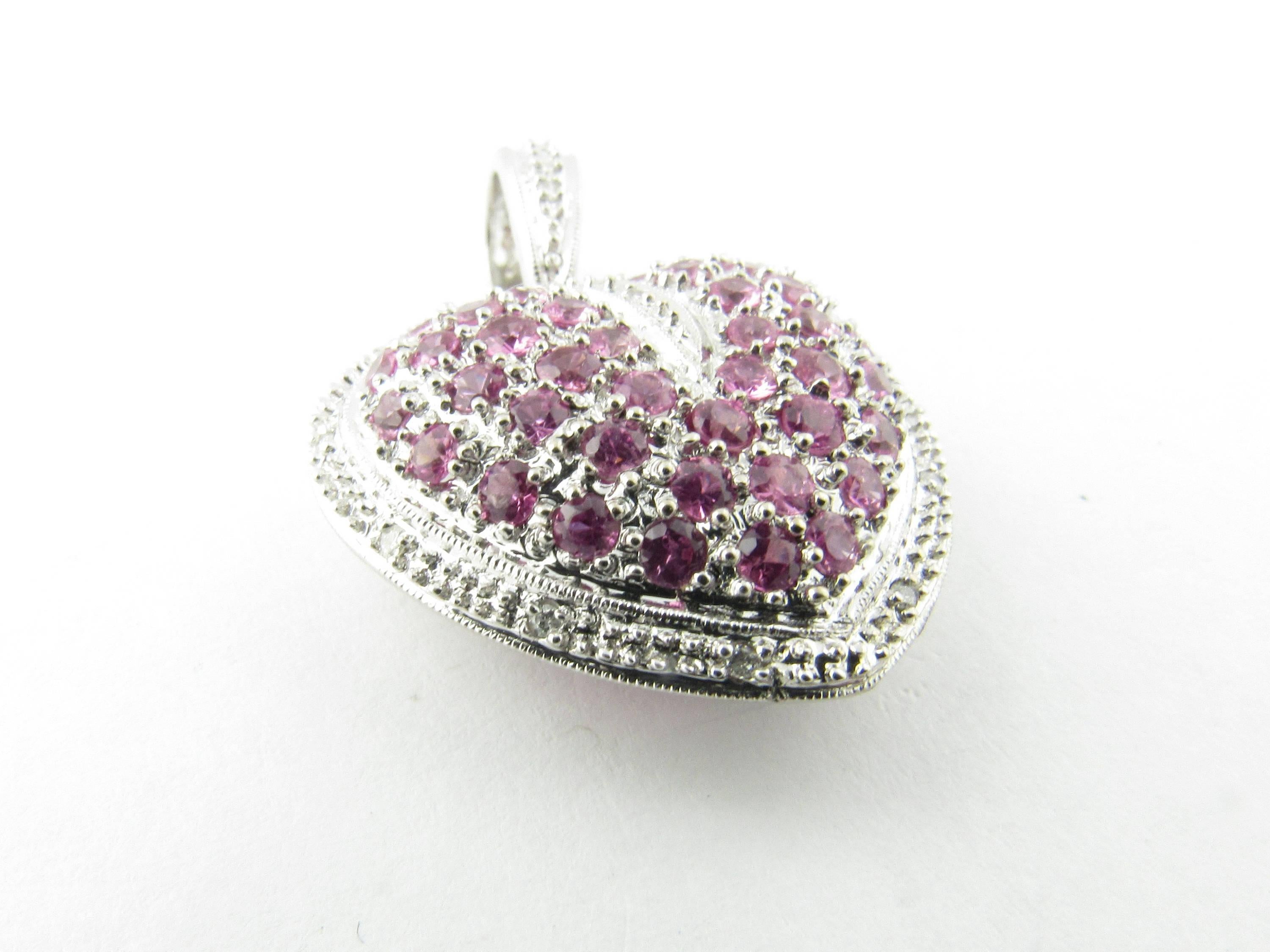 Vintage 14 Karat White Gold Pink Topaz and Diamond Heart Pendant-

This dazzling 3D heart pendant features 40 pink topaz stones surrounded by 12 round brilliant cut diamonds set in beautifully detailed 14K white gold.

Approximate total diamond