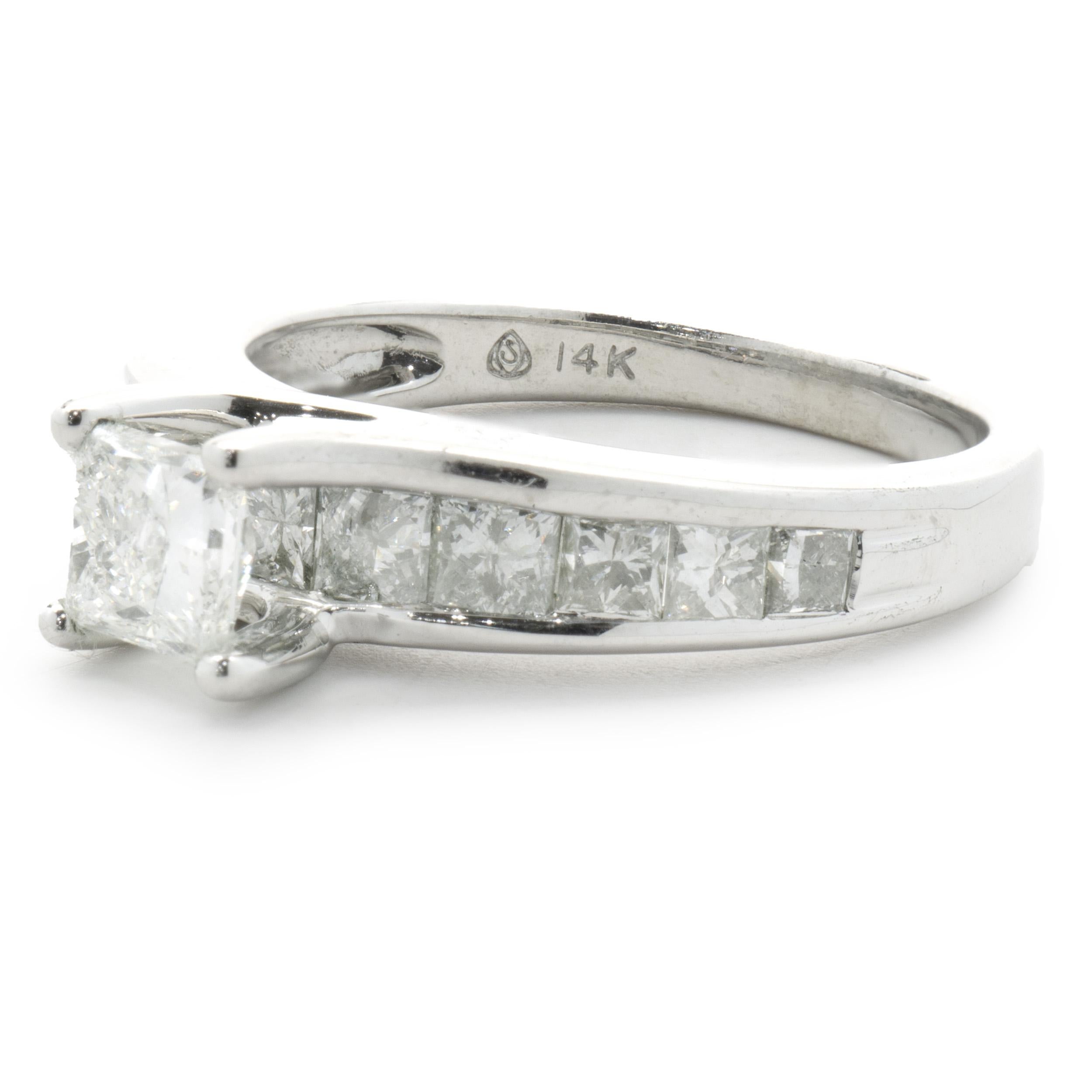 Designer: Custom
Material: 14K white gold
Diamond: 1 princes cut = 0.65ct
Color: G
Clarity: I1
Diamond: 11 princess cut = 1.65cttw
Color: G
Clarity: SI1
Dimensions: ring top measures 6mm wide
Ring Size: 8 (complimentary sizing available)
Weight: