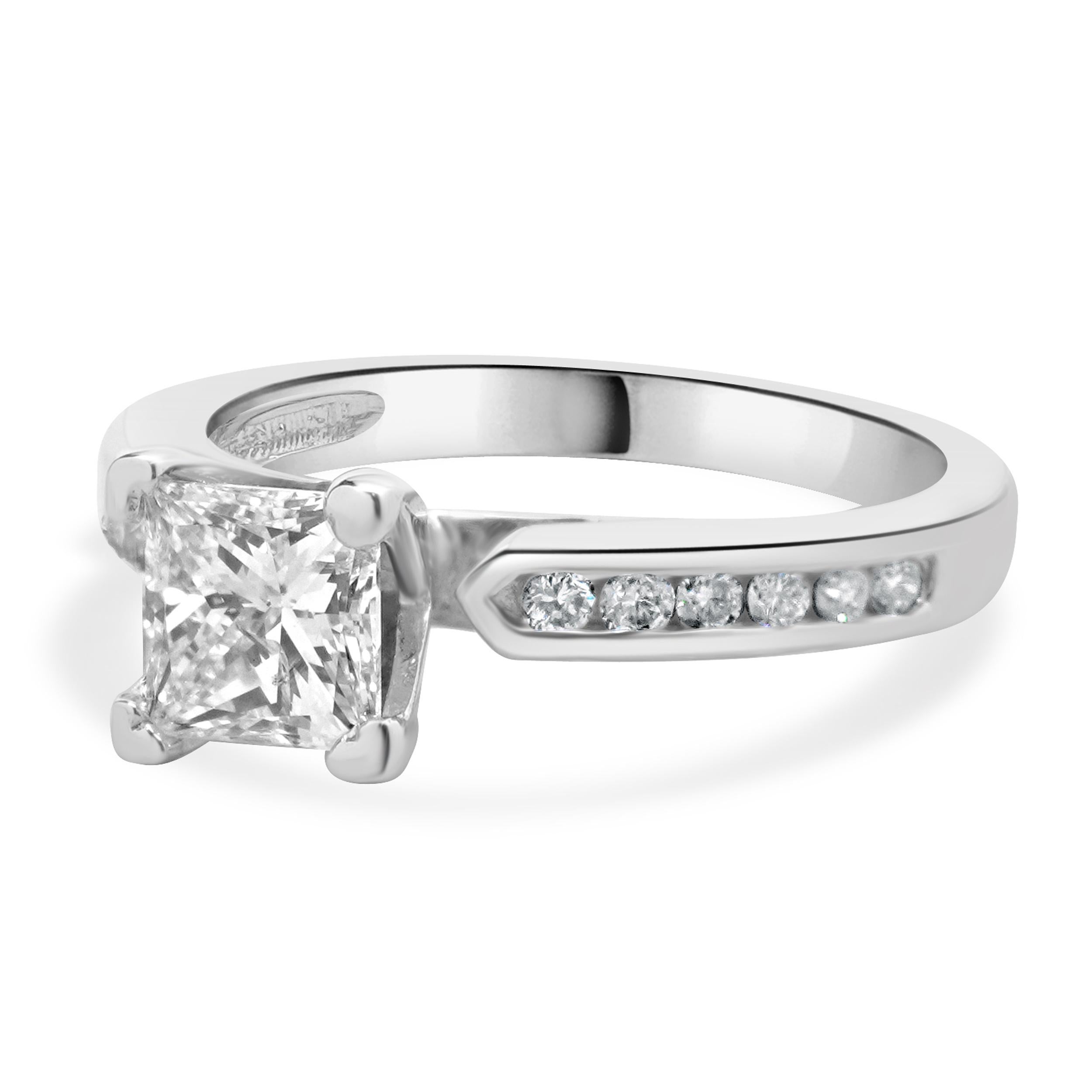 Designer: custom
Material: 14K white gold
Center Diamond: 1 princess cut = .97ct
Color : G
Clarity : I1
Diamond: 12 round brilliant cut = 0.24cttw
Color : H
Clarity : SI1
Dimensions: ring top measures 7mm
Size: 6.5 complimentary sizing available