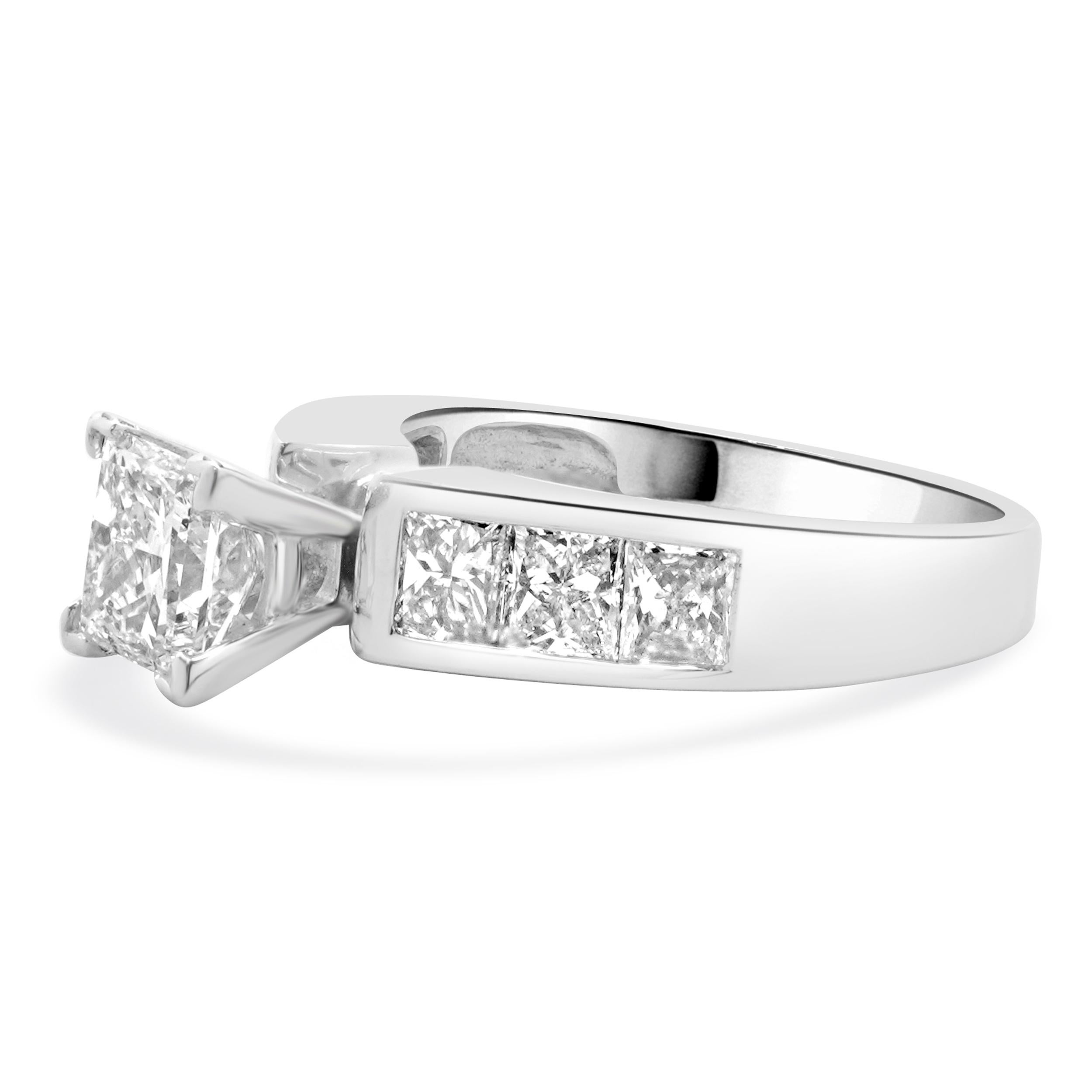 Designer: custom
Material: 14K white gold
Center Diamond: 1 princess cut = 1.00ct
Color : J
Clarity : SI2 
Diamonds: 6 princess cut = 1.30cttw
Color: J
Clarity: SI2
Size: 5.25 complimentary sizing available 
Weight: 4.82 grams
