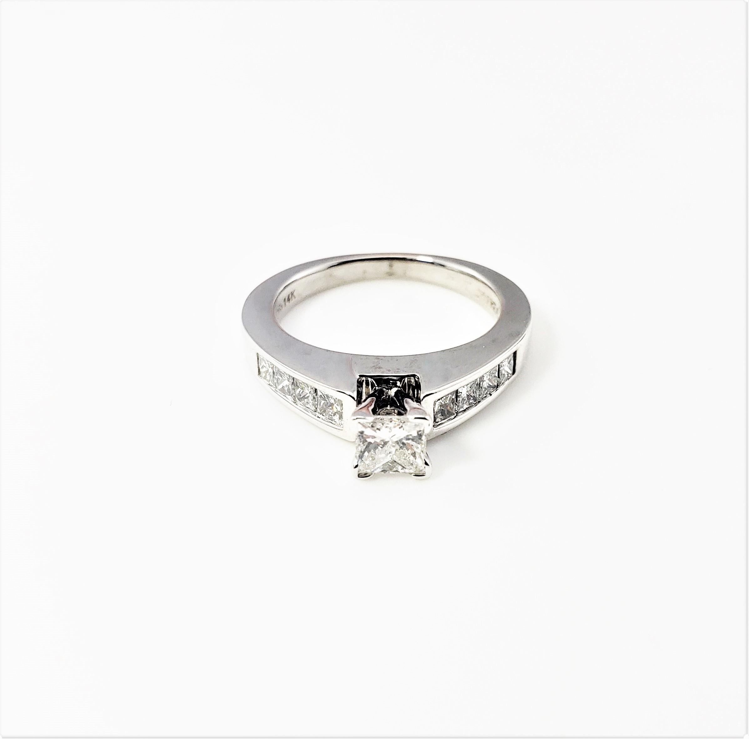 Vintage 14 Karat White Gold Princess Cut Diamond Engagement Ring Size 5.25-

This sparkling engagement ring features one princess cut diamond in its center (.35 ct.) and eight graduated princess cut diamonds (.52 ct. TWT.) on its band. Shank: 2 mm.