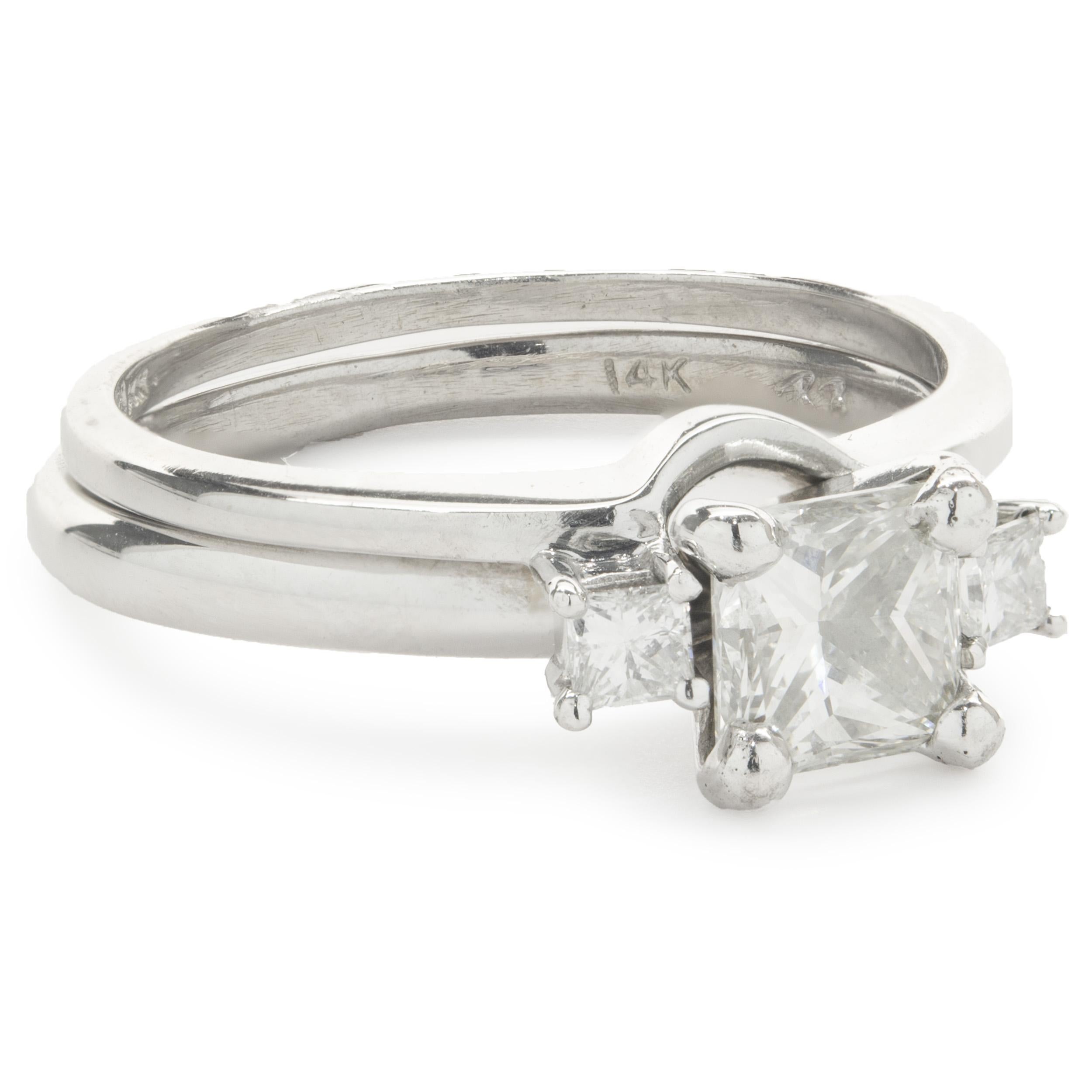 Designer: custom
Material: 14K white gold
Diamond: 1 princess cut = 0.83ct
Color: K
Clarity: VS2
Diamond: 2 princess cut = 0.15cttw
Color: H
Clarity: SI1
Ring Size: 8 (please allow two additional shipping days for sizing requests)
Dimensions: ring