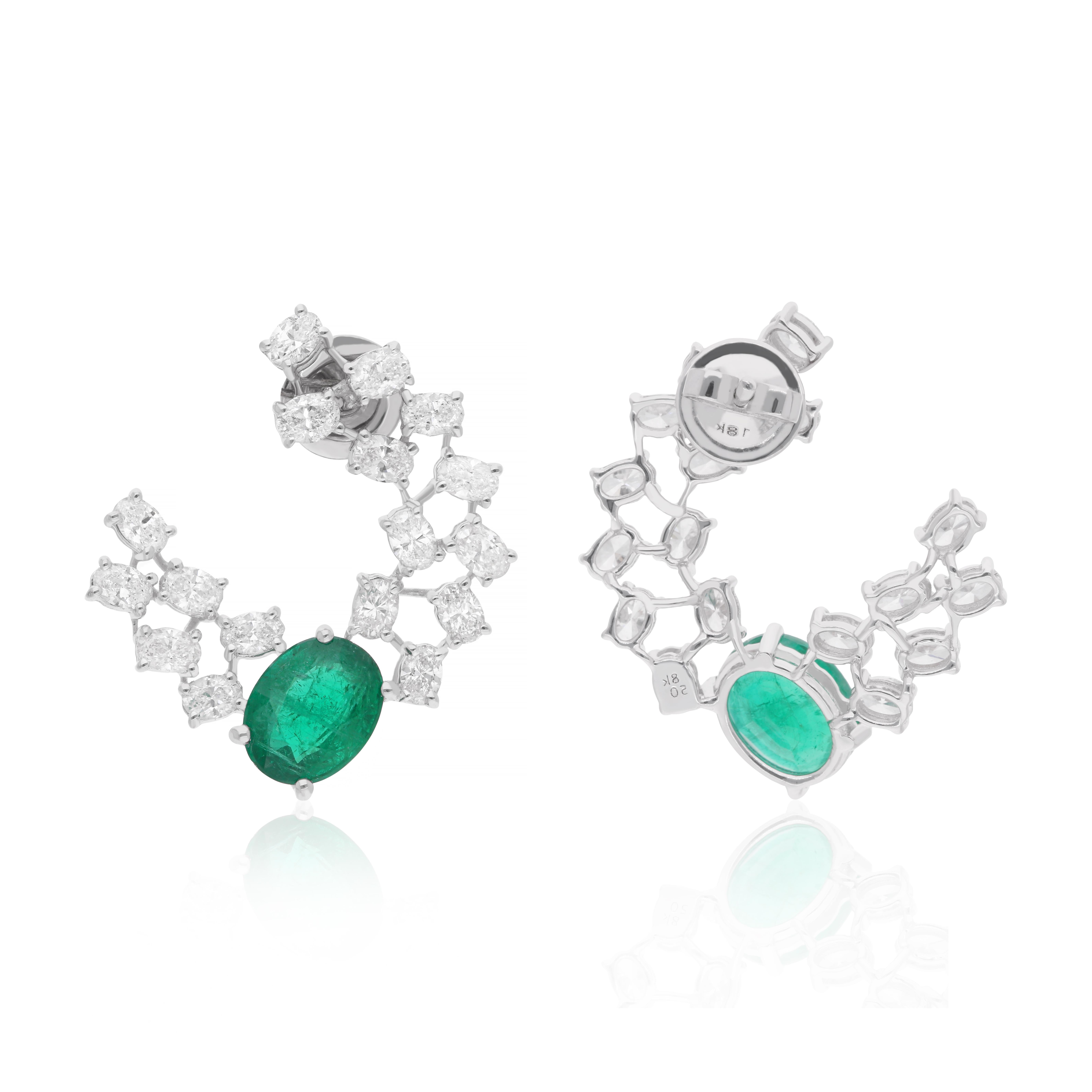 Surrounding the emeralds are dazzling diamonds, meticulously set to enhance their beauty and create a captivating halo effect. Crafted from the finest quality materials, these diamonds shimmer with every movement, adding an extra touch of glamour