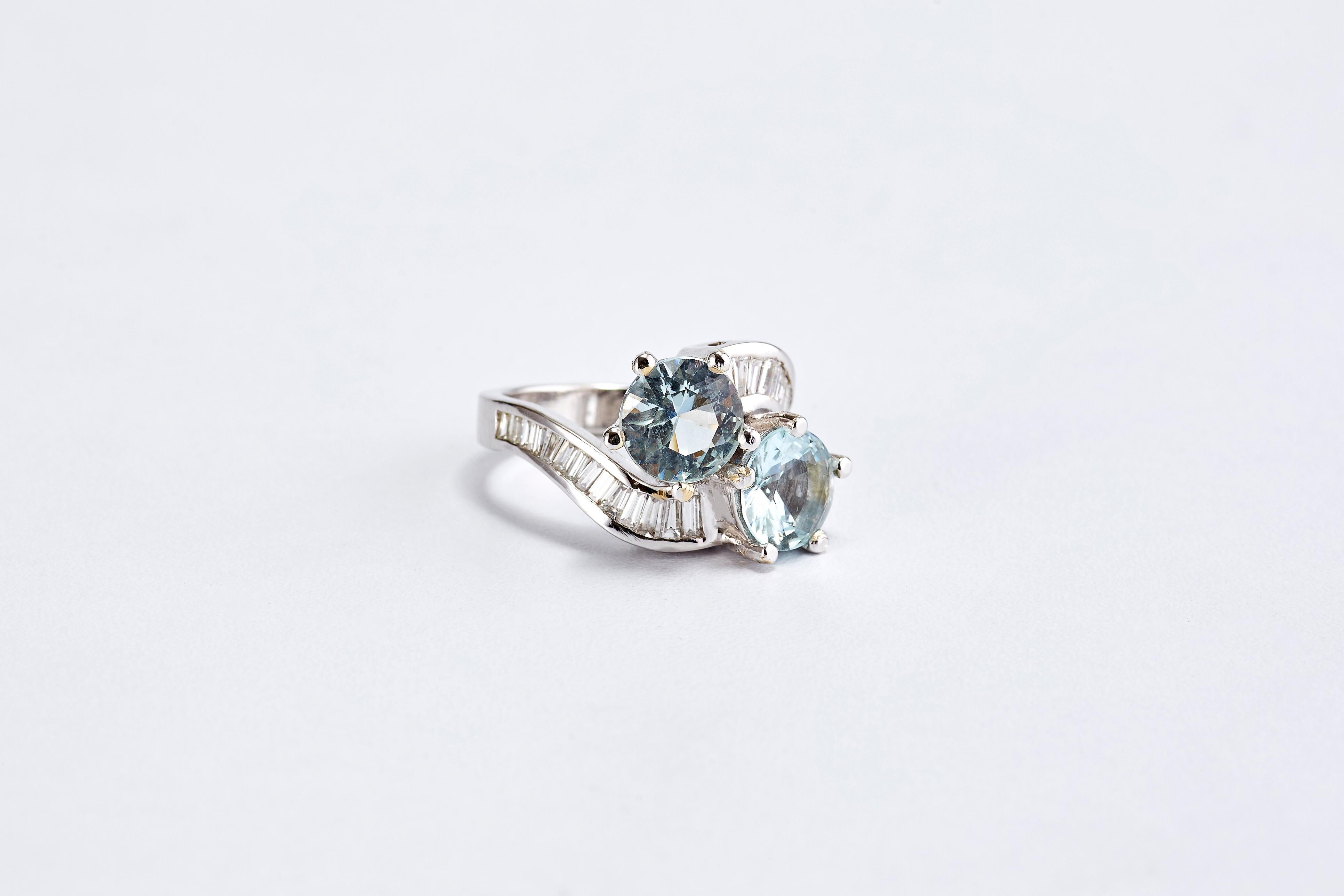 14 Karat White Gold Ring with 2 Aquamarine and Diamonds 
Two round aquamarine center stones, followed by 2 rows of baguette diamonds. Stunning and impressive ring, very in style.
Aquamarine is total 5.5 ct. Quality diamonds G VS1 total weight about