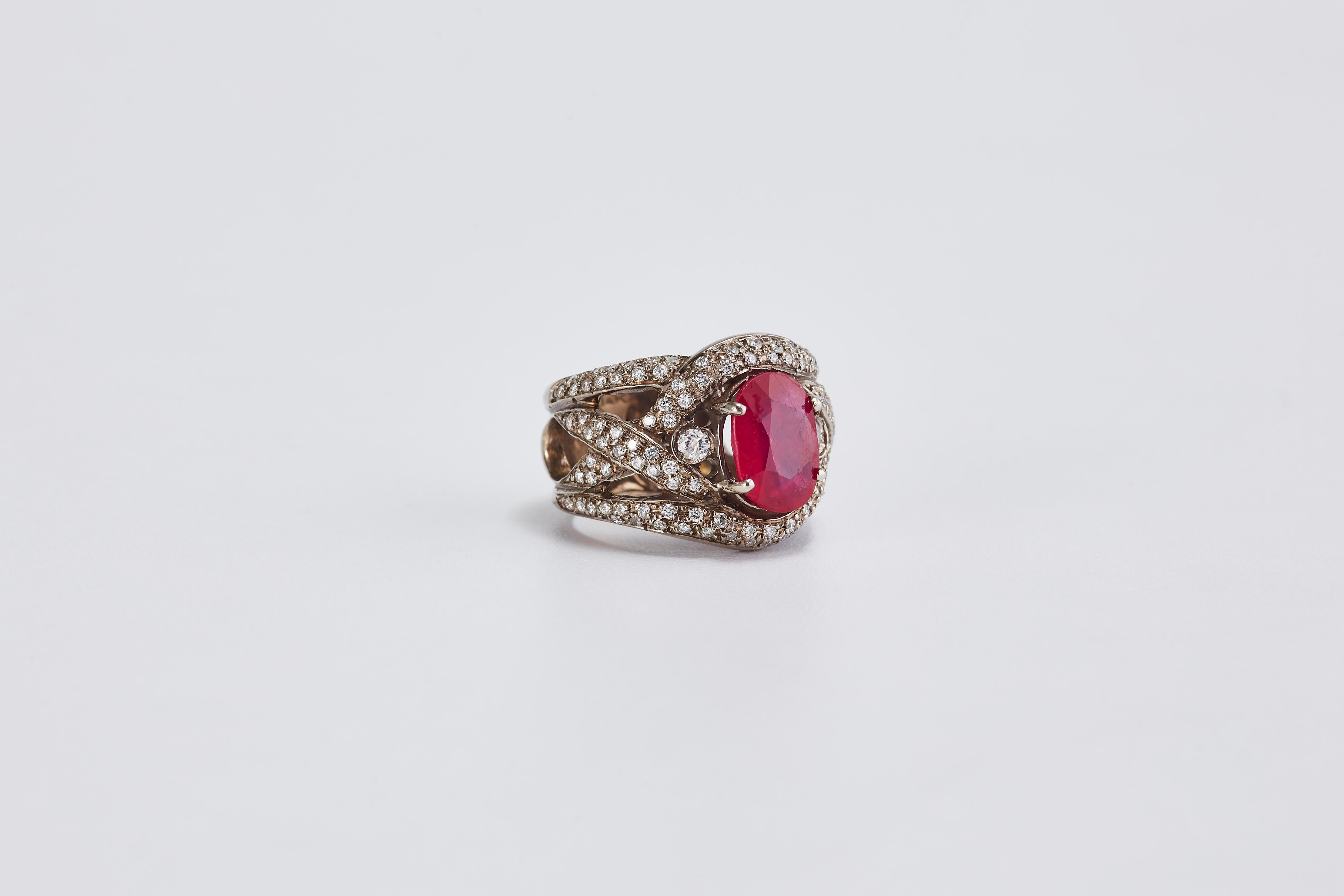 14 Karat White Gold Ring with Center Stone Ruby and Diamonds
Lovely gold ring with center oval cut Ruby and band filled with diamonds.
Ruby is 2.5 ct.
Quality diamonds G VS2 total of 2.30 ct. 
Total weight: 10.05 grams. Size: 6 US