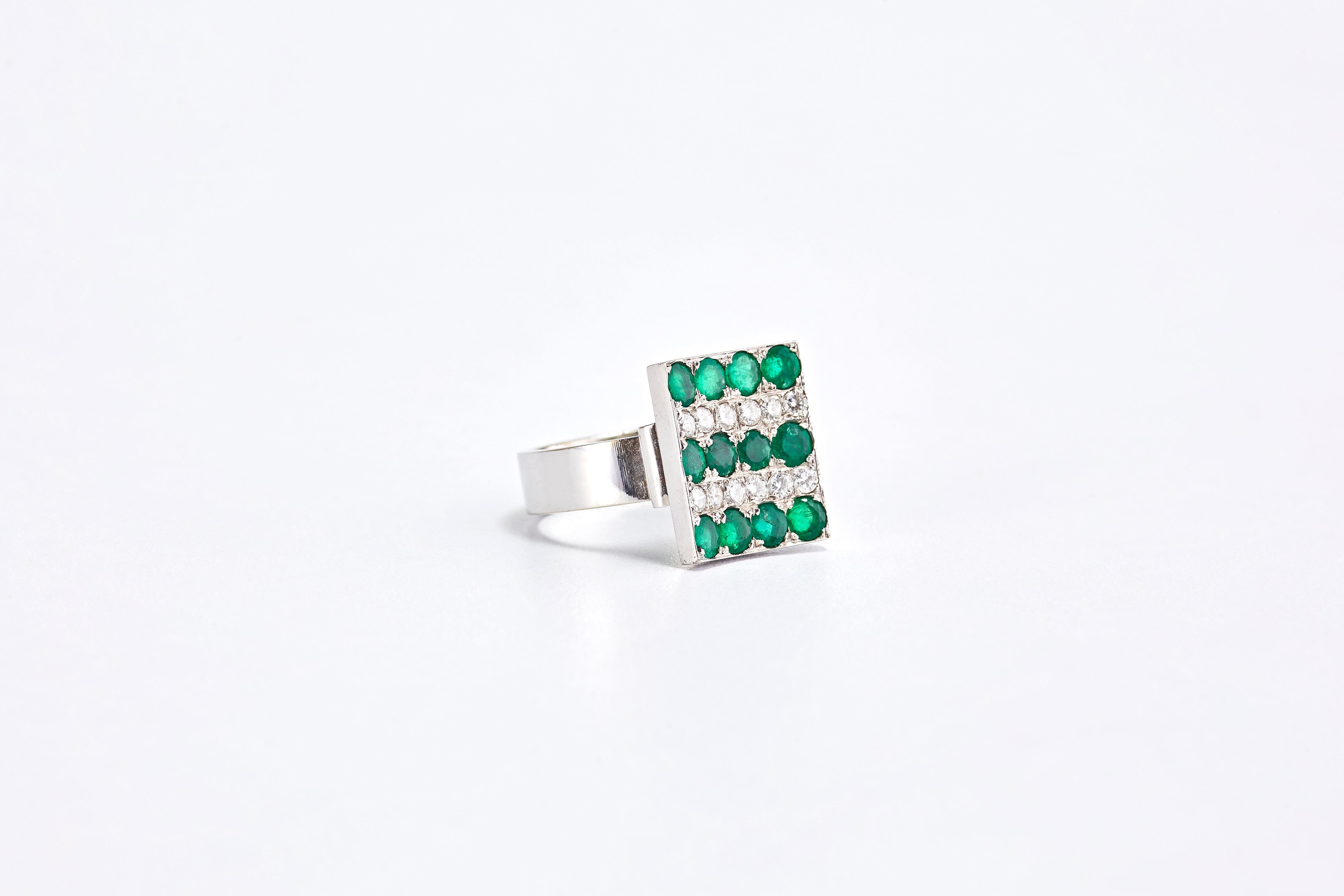 14 Karat White Gold Ring with Emerald Stones and Diamonds

Elegant white gold ring with 5 rows of stones. 2 rows of diamonds and 3 rows of round cut emeralds.
Emerald stones 1.80 ct. Diamonds 0.96 ct.
Total weight: 8.45 grams. Size: 7.5 US but