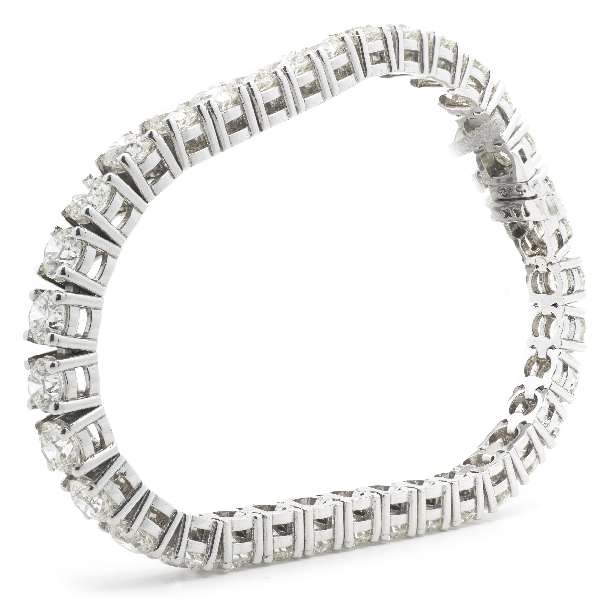 Designer: custom
Material: 14K white gold
Diamonds: 32 round brilliant cut = 17.69cttw
Color: G/H
Clarity: VS1-2
Dimensions: bracelet will fit up to an 7-inch wrist
Weight: 25.82 grams
