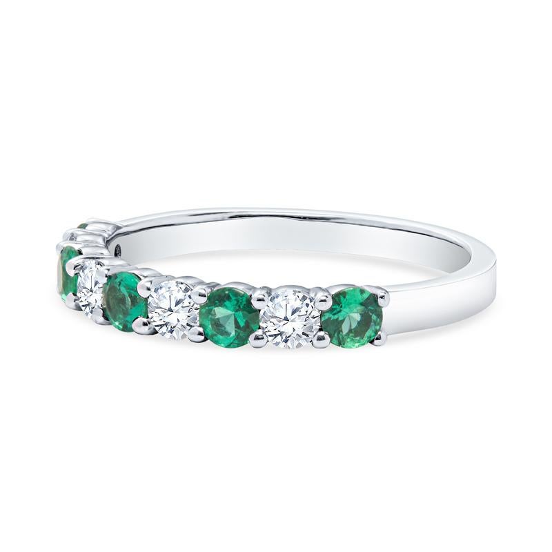 This band features 0.92 carat total weight in round emeralds alternating with 0.37 carat total weight in round diamonds set in 14 karat white gold. Wear with your engagement ring, stack with other bands, or wear alone. It is a size 6.25 but can be