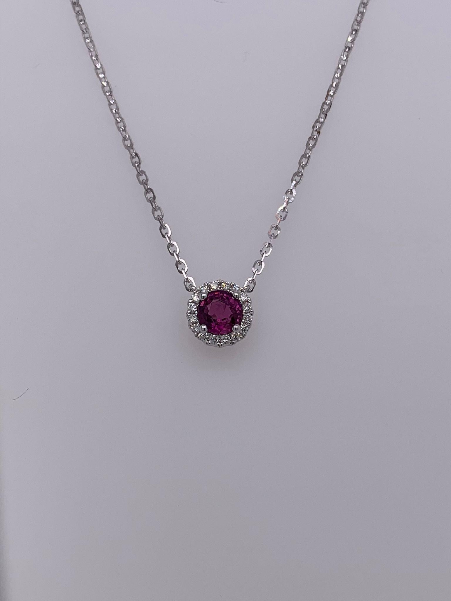 Round Ruby weighing 0.67 cts
Measuring 5.0 mm
Diamonds weighing 0.10 cts
Set in 14K white gold
