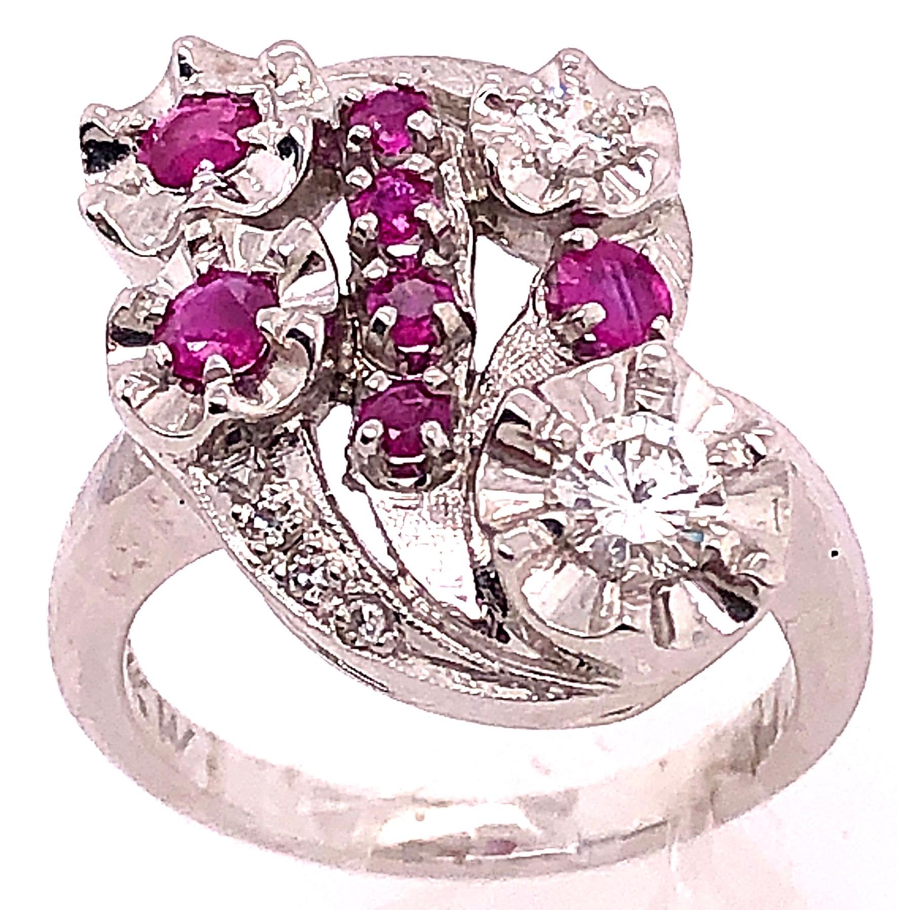 14 Karat White Gold Ruby And Diamond Cocktail Ring
7 piece round rubies
0.33 total diamond weight.
Size 6
Height: 25 mm Width: 18 mm
8 grams total weight.
