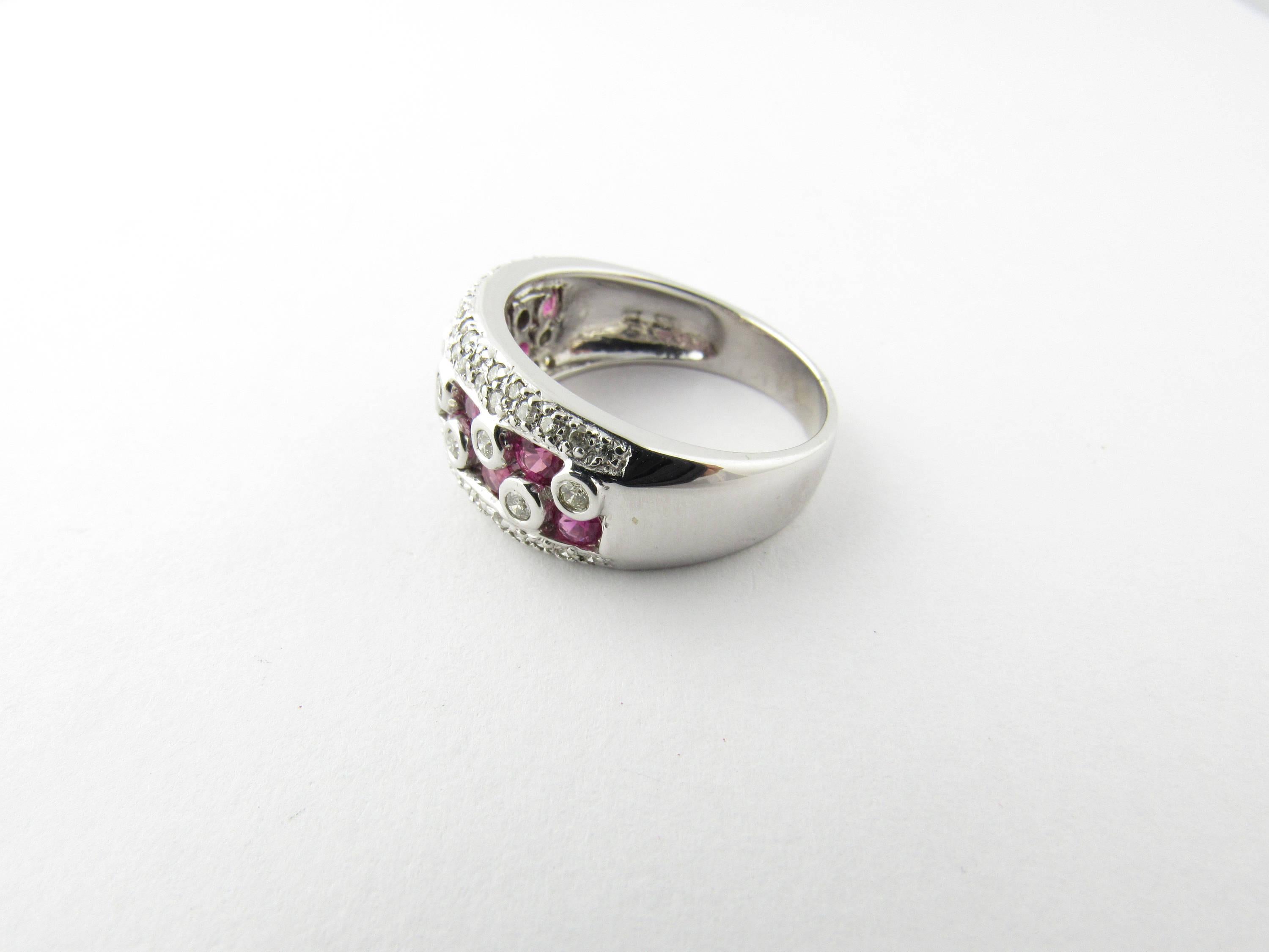 Vintage 14 Karat White Gold Ruby and Diamond Ring Size 8.75- 
This lovely band features 10 round brilliant cut diamonds (.30 ct. twt.) and 10 genuine round rubies ( 2 mm each) accented with two rows of round brilliant cut diamonds (26 on each side,