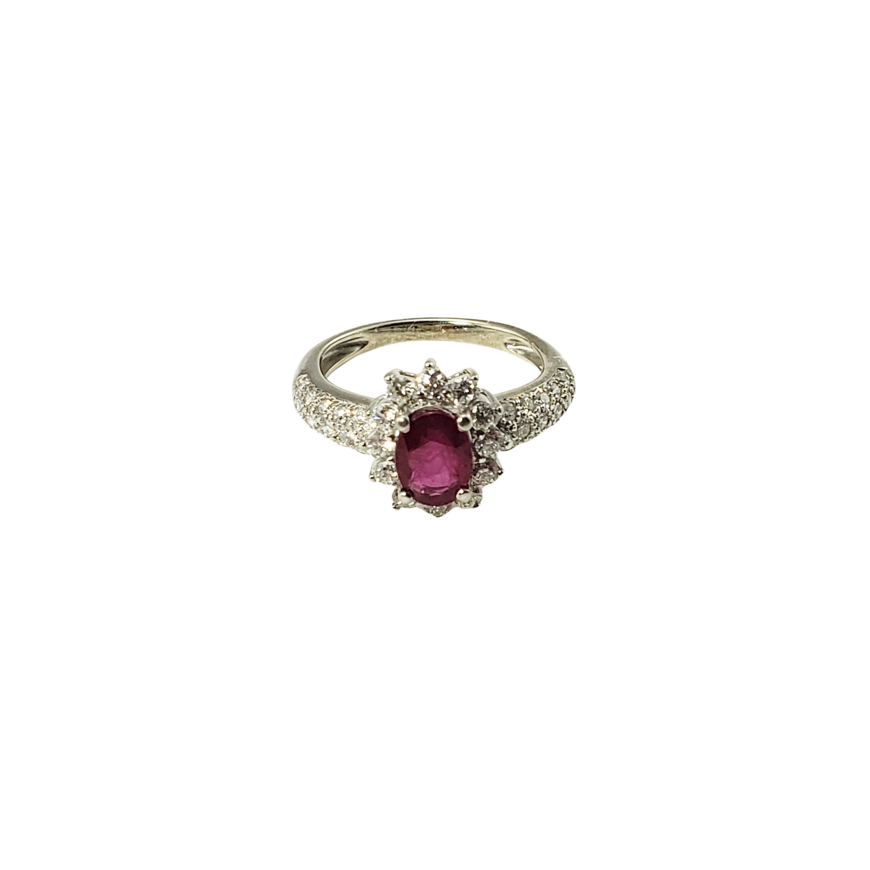 14 Karat White Gold Ruby and Diamond Ring Size 4.5 GAI Certified-

This lovely ring features one oval ruby (7 mm x 5 mm) and 42 round brilliant cut diamond set in classic 14K white gold.  Top of ring measures 11 mm x 10 mm.  Shank:  2 mm.

Ruby