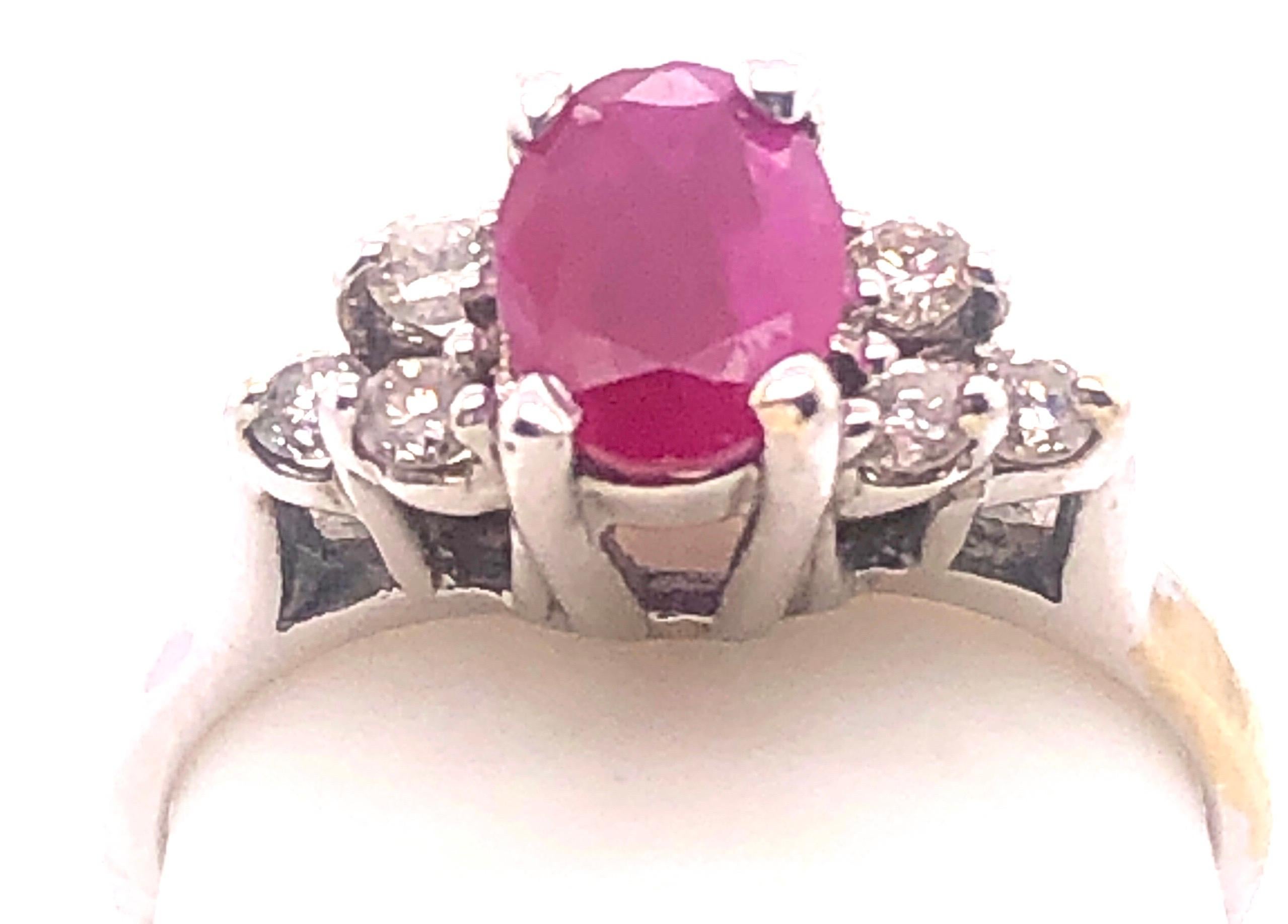 14 Karat White Gold Contemporary Ruby Ring with Round Diamonds.
Size 6.25
3.10 grams total weight.