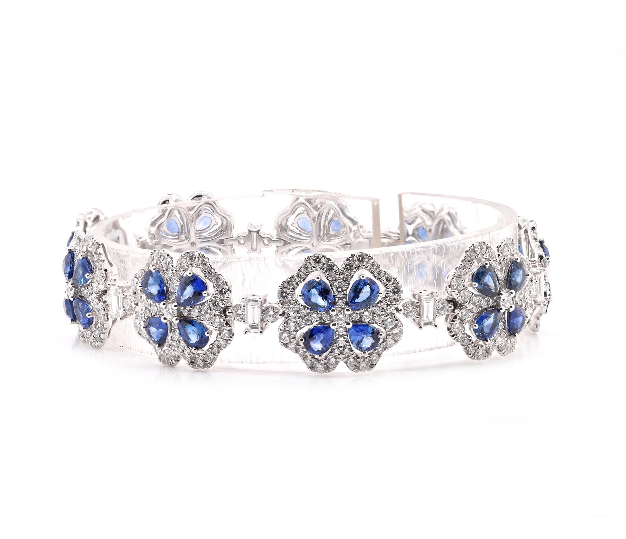 Designer: custom
Material: 14K white gold
Sapphire: 36 pear cut = 9.37cttw
Color: Blue
Clarity: AAA+
Diamond: 9 baguette and 415 round brilliant cut = 5.60cttw
Color: G
Clarity: VS
Weight:  26.03 grams
Dimensions: bracelet measures 7-inches
