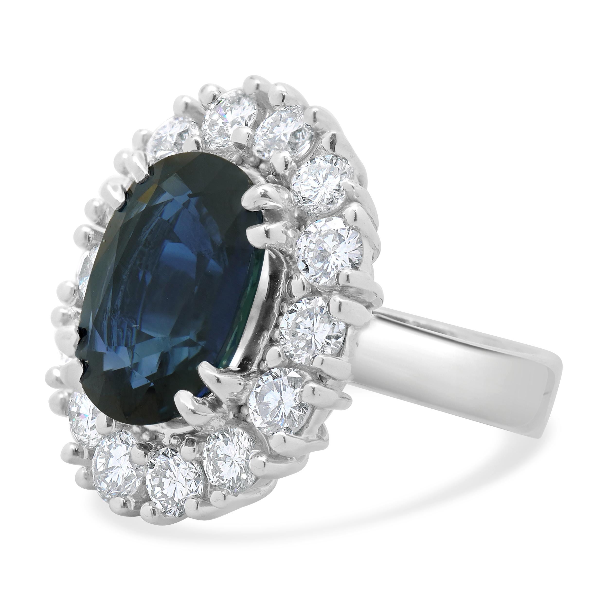 Designer: custom
Material: 14K white gold
Diamond:  round brilliant cut = 5.06cttw
Color: G
Clarity: SI1
Oval Sapphire:  9.65cttw
Ring Size: 7 (please allow two extra shipping days for sizing requests) 
Weight: 21.86 grams
