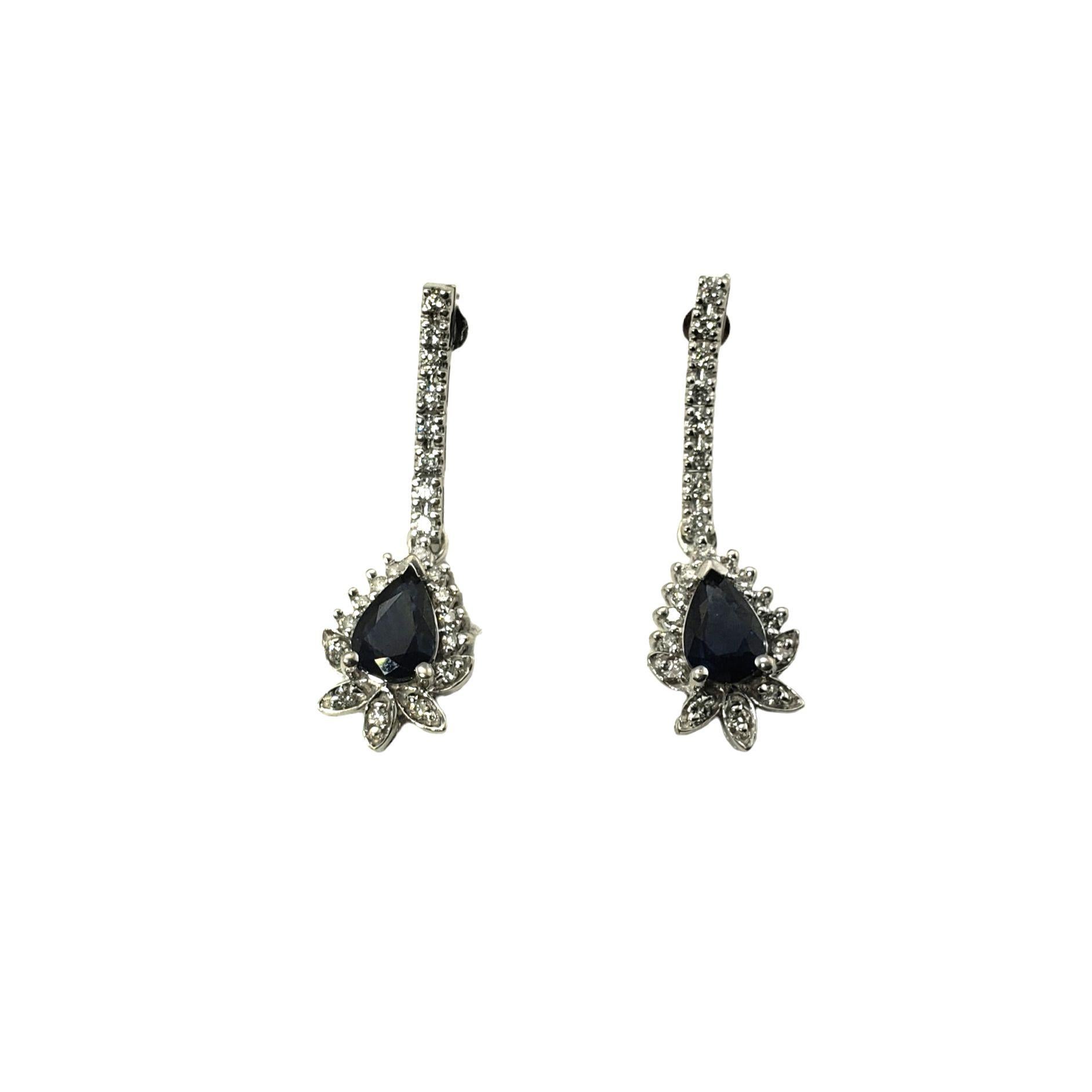 Vintage 14 Karat White Gold Natural Sapphire and Diamond Dangle Earrings-

These lovely earrings each feature one pear shaped sapphire (approx. 6.7 x 5.0 mm) and 44 round brilliant cut diamonds set in classic 14K white gold.  Push back