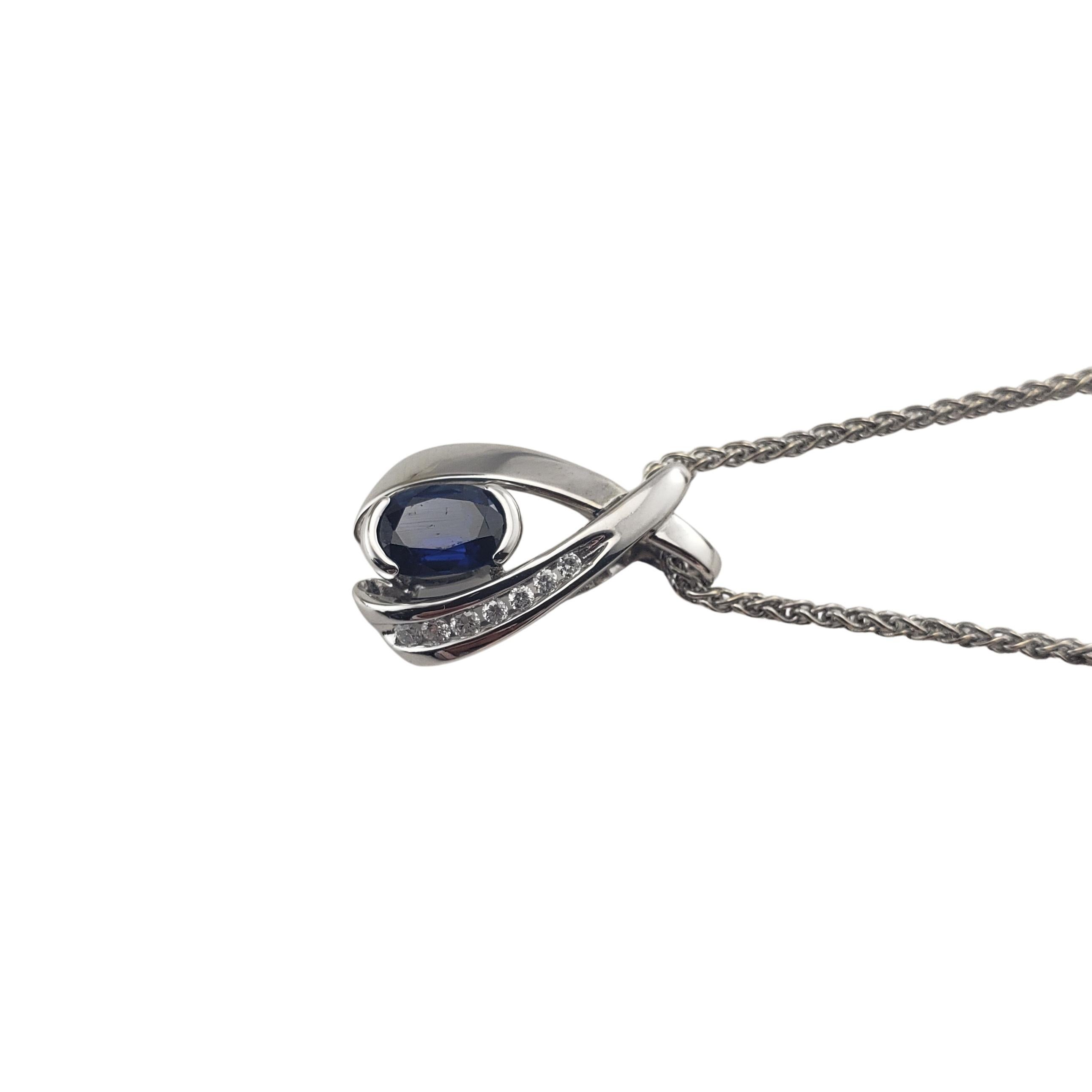 Vintage 14 Karat White Gold Sapphire and Diamond Pendant Necklace-

This stunning pendant features one oval sapphire (6 mm x 5 mm) and seven round brilliant cut diamonds set in 14K white gold. Suspends from a classic white gold