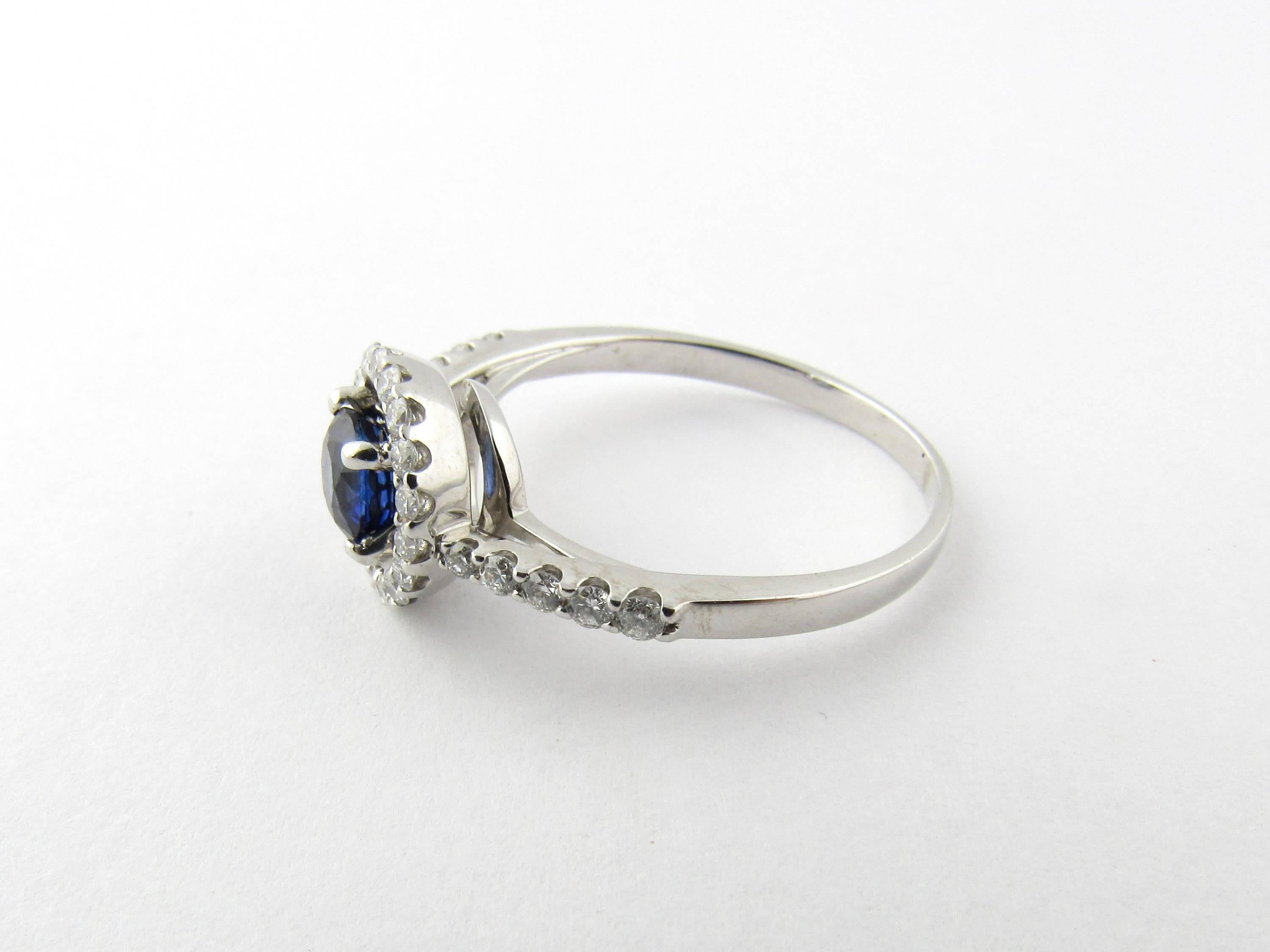 Vintage 14 Karat White Gold Natural Sapphire and Diamond Ring Size 8.5-

This lovely ring features one genuine blue sapphire (.71 ct.) accented with 28 round brilliant cut diamonds set in beautifully detailed white gold.

Approximate total diamond