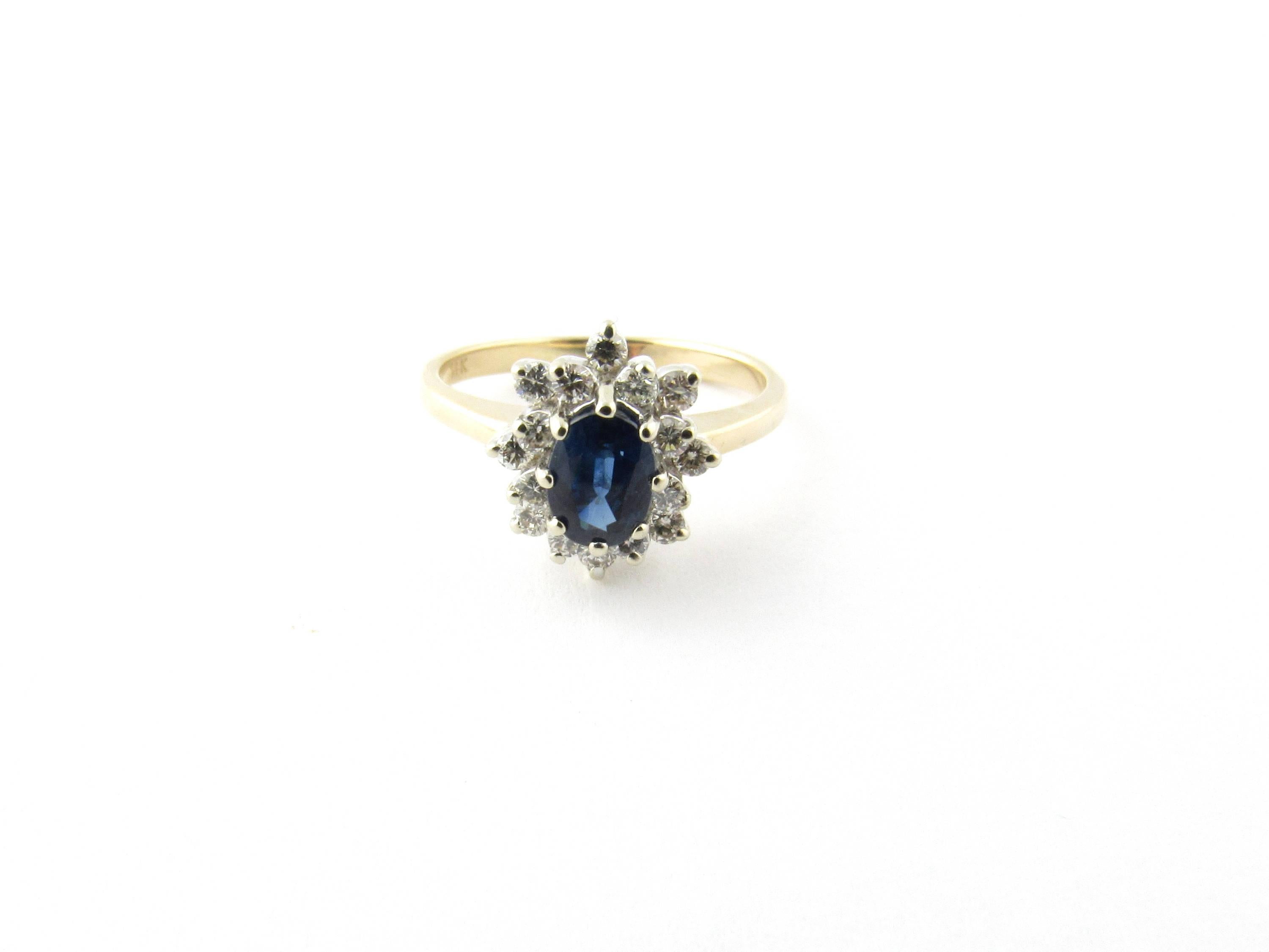 Vintage 14 Karat White and Yellow Gold Sapphire and Diamond Ring Size 5.5-

This elegant ring features one oval sapphire (7 mm x 5 mm) surrounded by 16 round brilliant cut diamonds set in classic 14K white gold. Top of ring measures 11 mm x 10 mm.