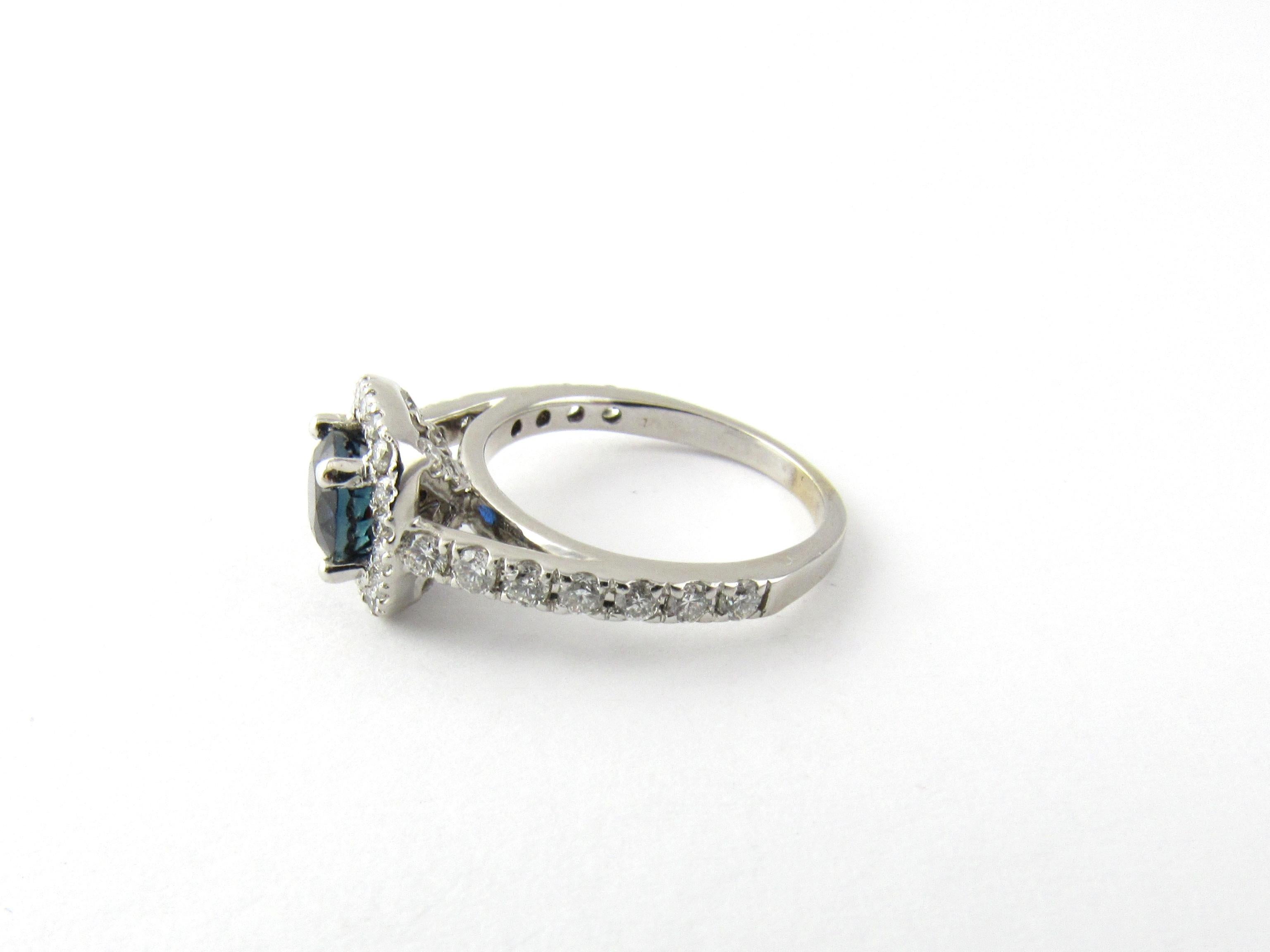 Vintage 14 Karat White Gold Natural Sapphire and Diamond Ring Size 4.75- 
This stunning ring features one round sapphire (6 mm) surrounded by 25 round brilliant cut diamonds set in beautifully detailed 14K white gold. Shank measures 2 mm.