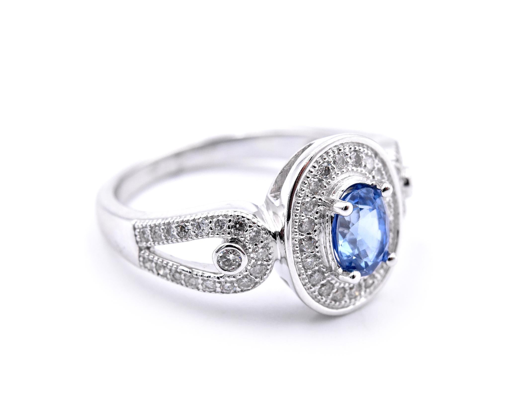 Material: 14 karat white gold
Gemstones: sapphire = .91ct Ceylon Oval Cut
Diamonds: .49cttw
Color: F
Clarity:  VS2-SI
Ring Size: 7.5 (please allow two additional shipping days for sizing requests)
Dimensions: ring top measures 12.67mm  X 10.48mm