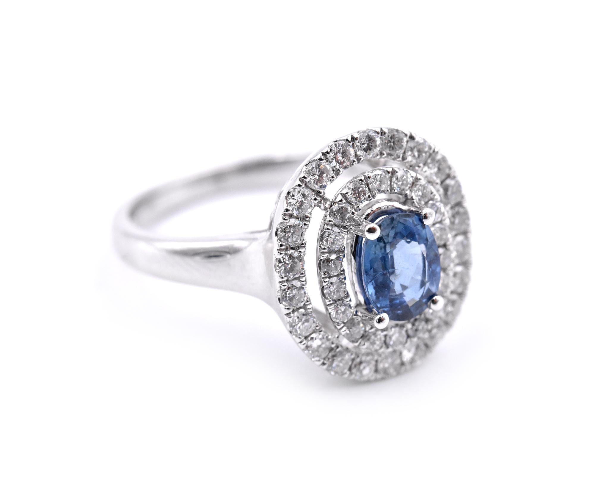 Designer: custom design
Material: 14k white gold
Gemstones: Sapphire = .78ct OVAL
Certification: AGI A1158
Diamonds: 40 round brilliant cuts = .70cttw
Color: G
Clarity: VS2-SI
Ring Size: 7.5 (please allow two additional shipping days for sizing