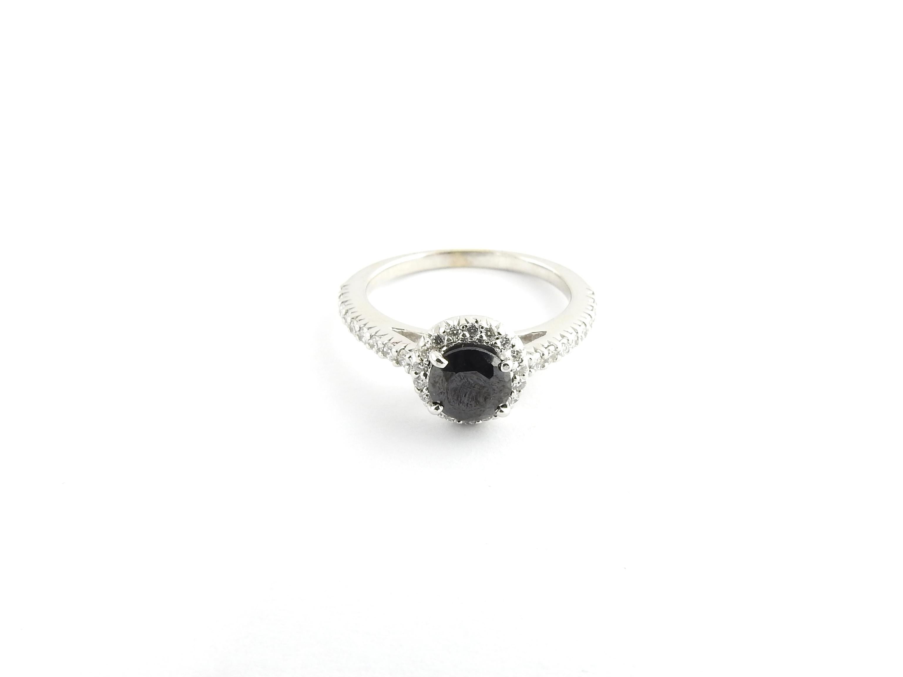 Vintage 14 Karat White Gold Black and White Diamond Ring Size 7-

This elegant ring features one round black diamond (6 mm) approx. .75cts accented with 35 round brilliant cut diamonds approx. .53cts set in classic 14K white gold.  

Top of ring