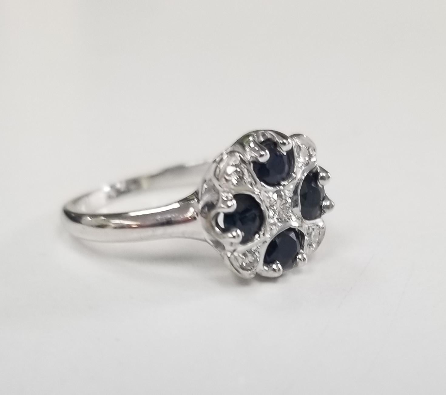 14k white gold sapphire and diamond ring, containing 4 round cut sapphires of fine quality weighing .70pts. and 5 round full cut diamonds of very fine quality weighing .13pts. in an 