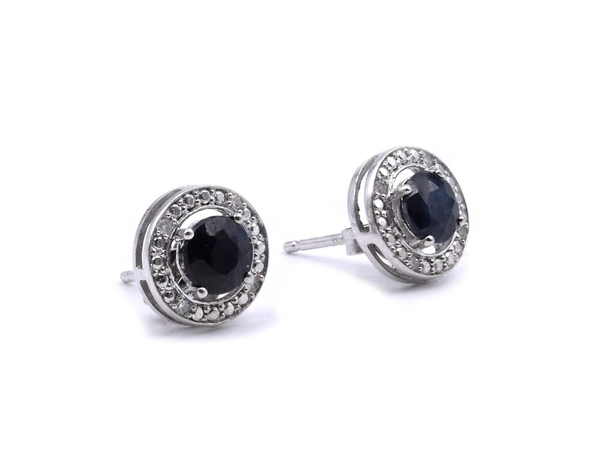 Material: 14K white gold
Diamond: 8 round cut =.08cttw
Color: H
Clarity: SI2
Sapphire: 2 round cut = .50cttw
Fastenings: post with friction backs
Measurements: earrings measure 7.50mm
Weight:  .82 grams	

