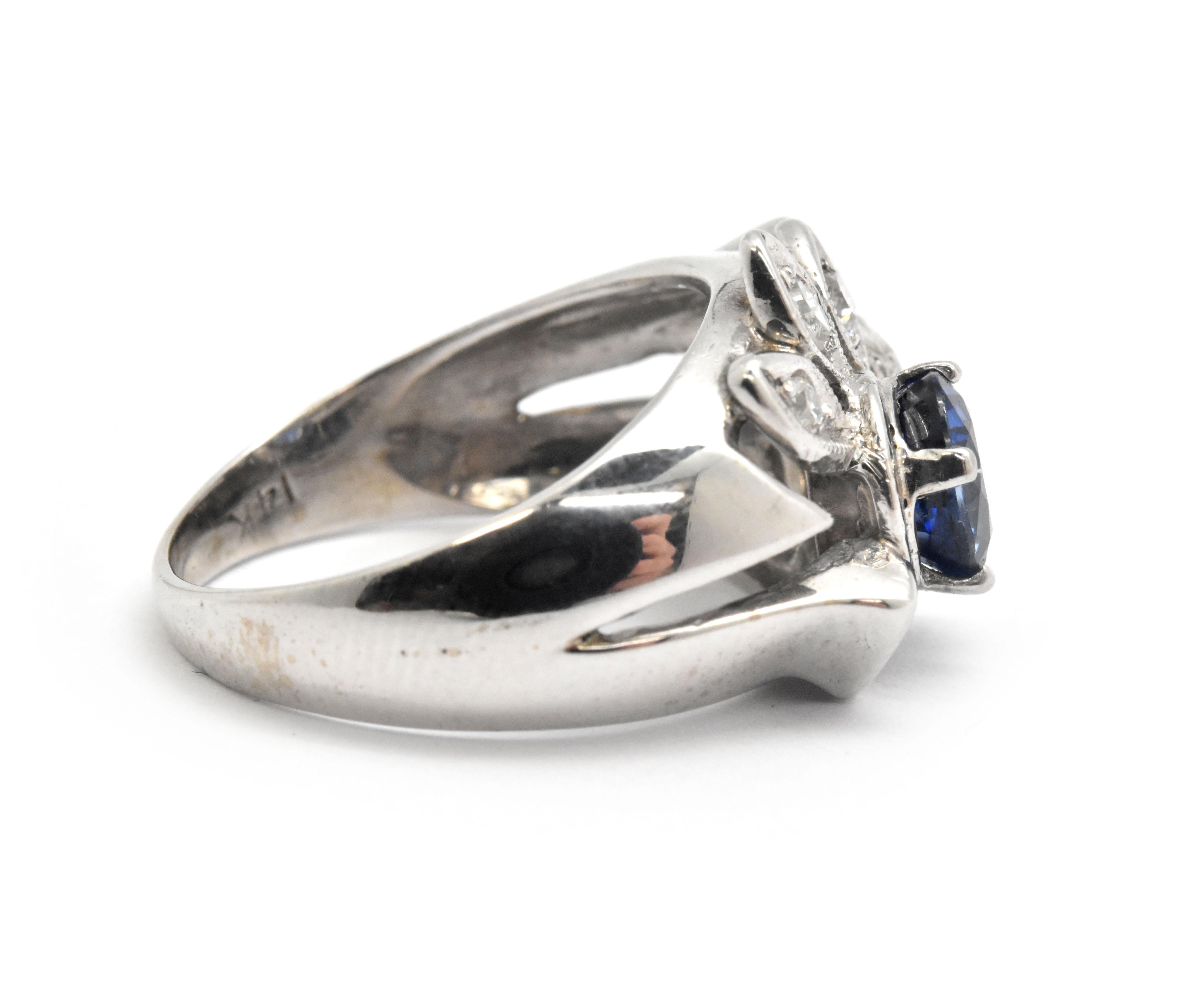 This fabulous cocktail ring features an oval shaped sapphire prong set into the top of the ring. Set around the lovely sapphire are 6 diamond accents equaling 0.15ctw. The sapphire is an exceptional deep blue color, oval cut and measures 6.8x5.6mm