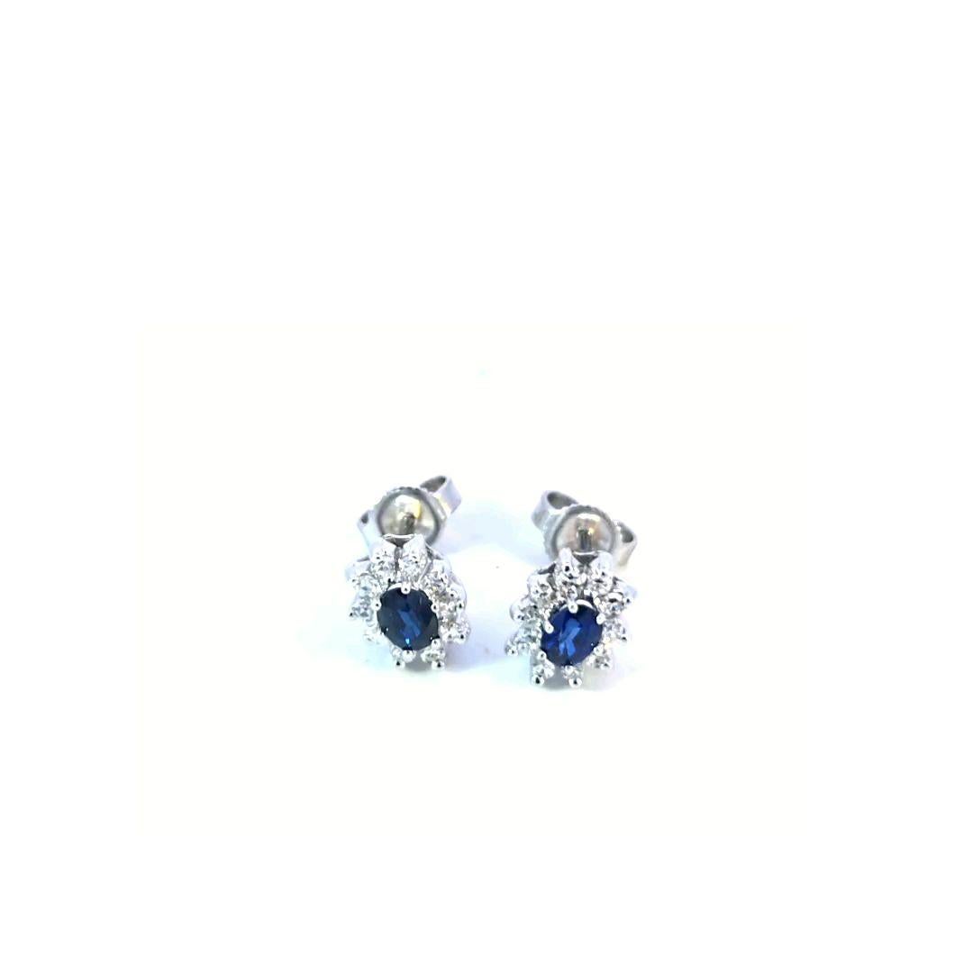 Bright and lively oval blue sapphires surrounded by full-cut diamonds. 