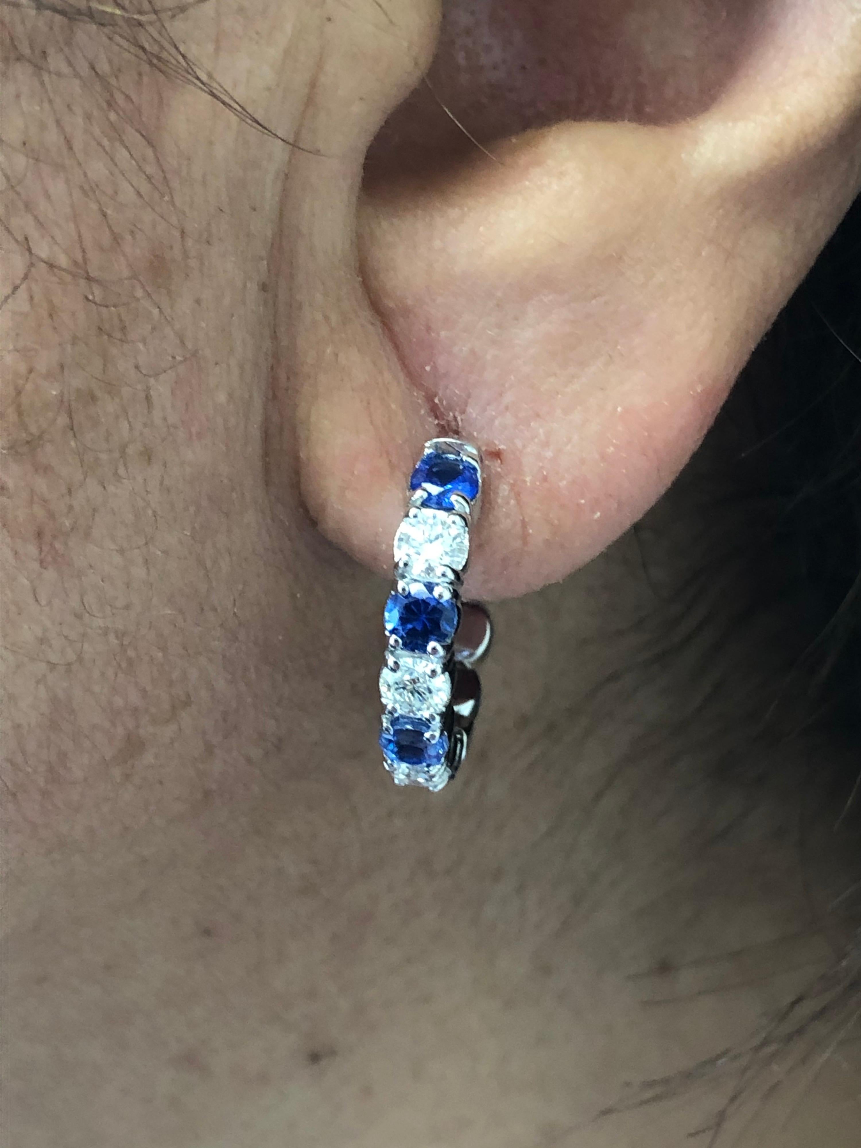 Sapphire and Diamond stones set in 14K white gold. The stones are set only on the outside of the hoop. The earrings are set with 8 sapphires and 6 diamonds. The sapphire weight is 1.73 carats and the diamond weight is 1.20 carats. The sapphires are