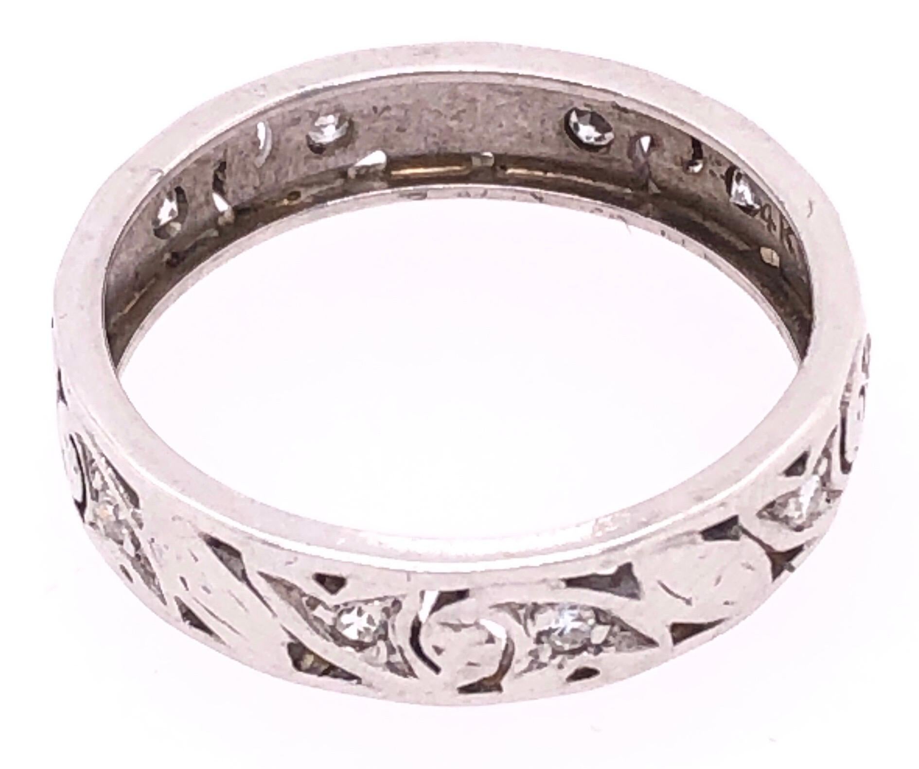 14 Karat White Gold Scroll Design Eternity Diamond Band Ring Size 8 .
0.42 total diamond weight.
2.77 grams total weight.