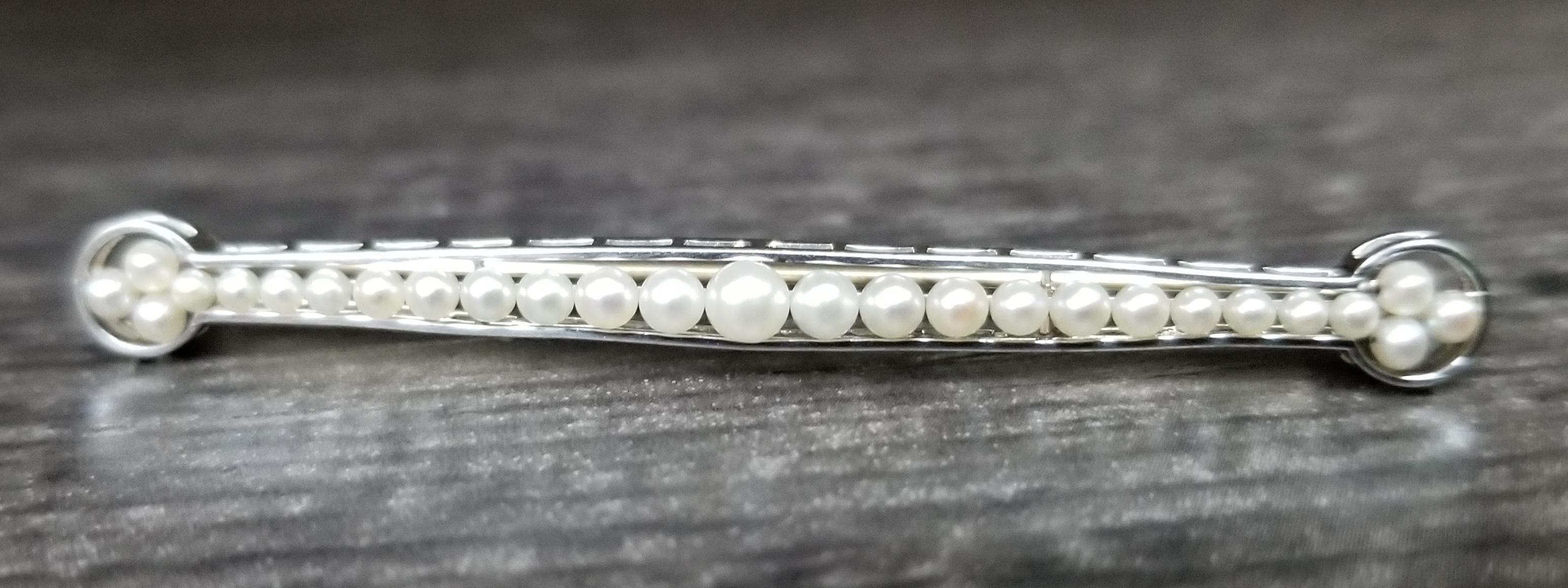 14k white gold sea pearl pin with 27 graduating sea pearls from 1.5mm to 3mm. 