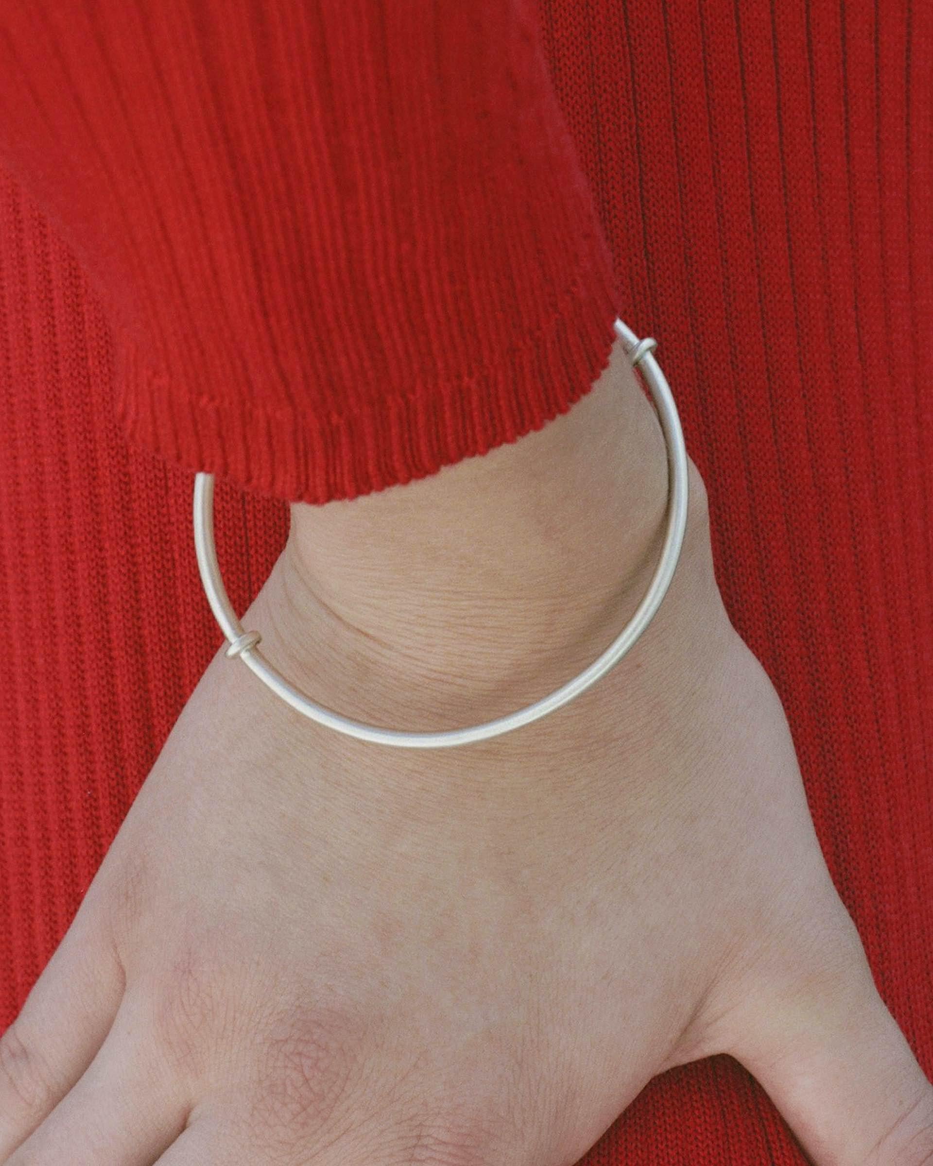 The Roman Bangle is a hand-wrought bangle bracelet with ancient influence. It is artisan-made in Los Angeles from recycled 14 karat white gold. It slips on with ease and wears beautifully on the wrist or over a sleeve. An elegant and resilient piece