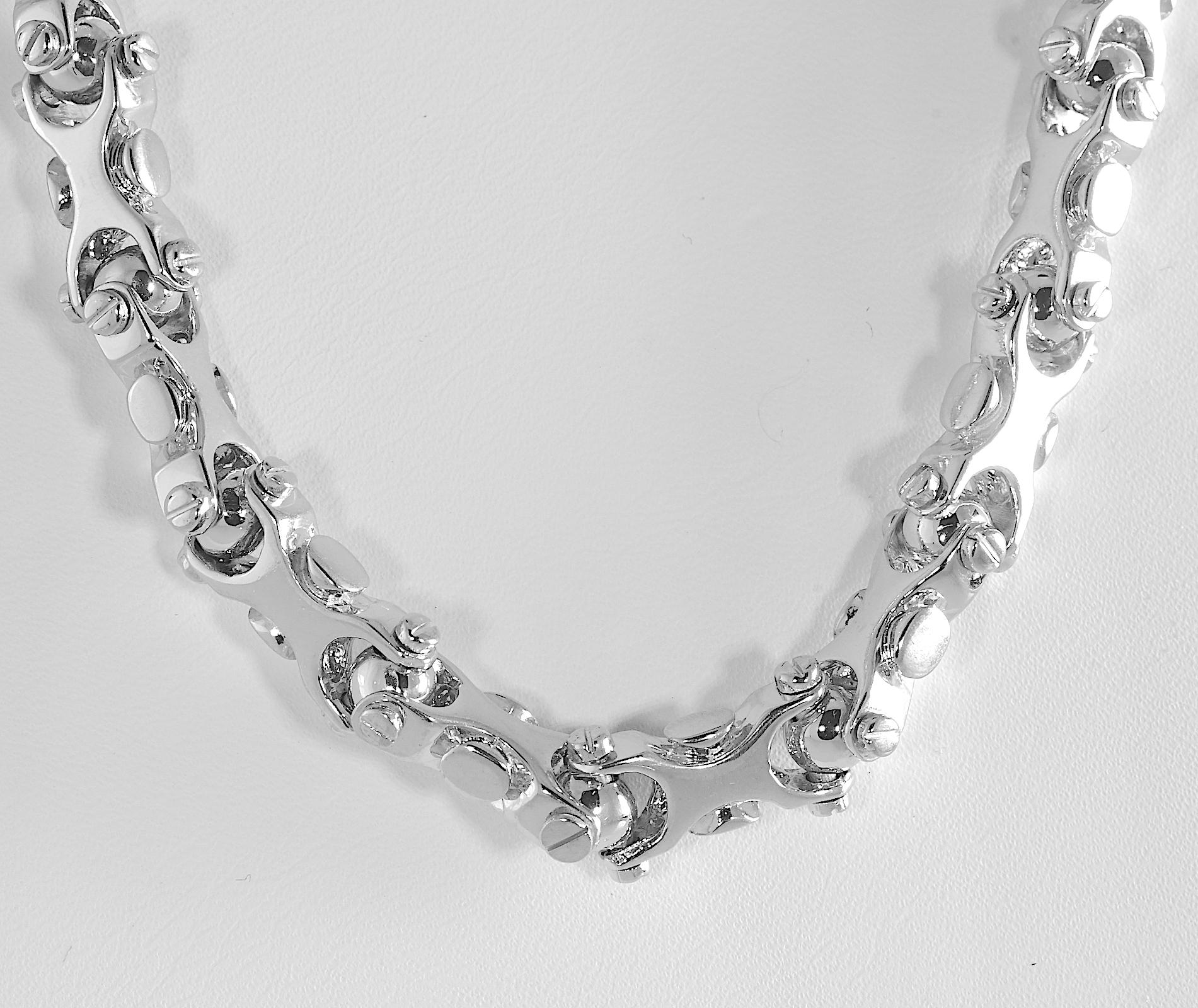 Unique 14 karat white gold geometrical links with screw hinges. The length of the necklace is 20 inches. The width is 3/8 inch. The weight is 143.0 grams. The closure is a swivel lobster claw.  Tested and guaranteed 14 karat.   

340029-1