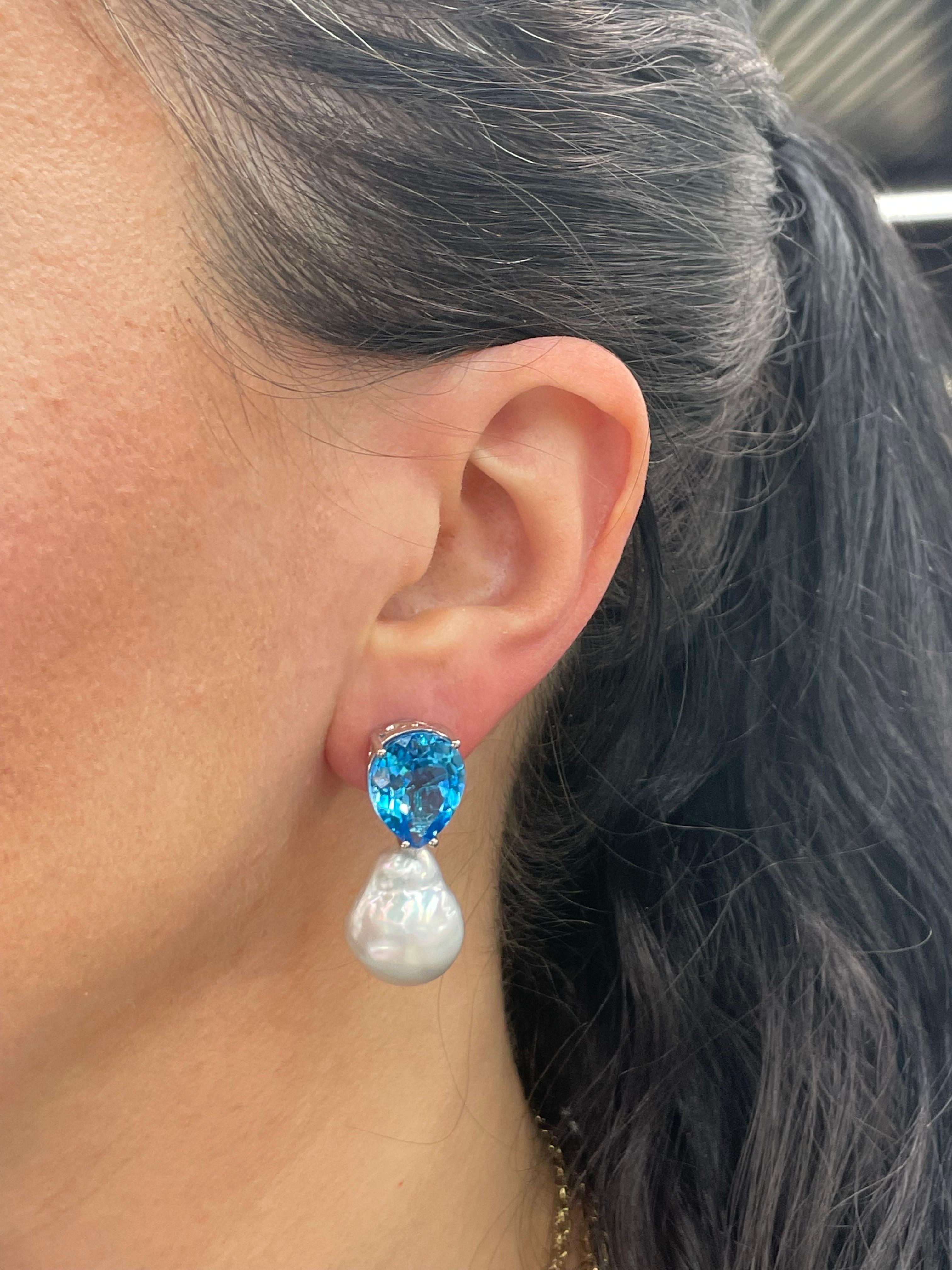14 Karat White Gold drop earrings featuring two pear shape Blue Topaz weighing 20.79 Carats and two baroque South Sea Pearls measuring 15-16 MM. 
Can customize Pearl color & size.
DM for more information. 