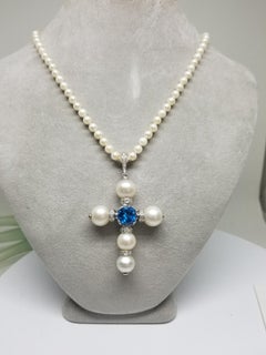 14 Karat White Gold South Sea Pearl Cross with a Swiss Blue Topaz and Diamonds