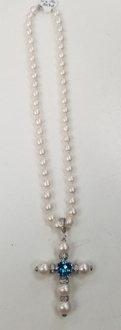 14 Karat White Gold South Sea Pearl Cross with a Swiss Blue Topaz and Diamonds